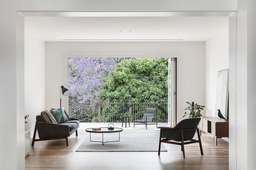 Cooks River House by studioplusthree. Living room view out to balcony