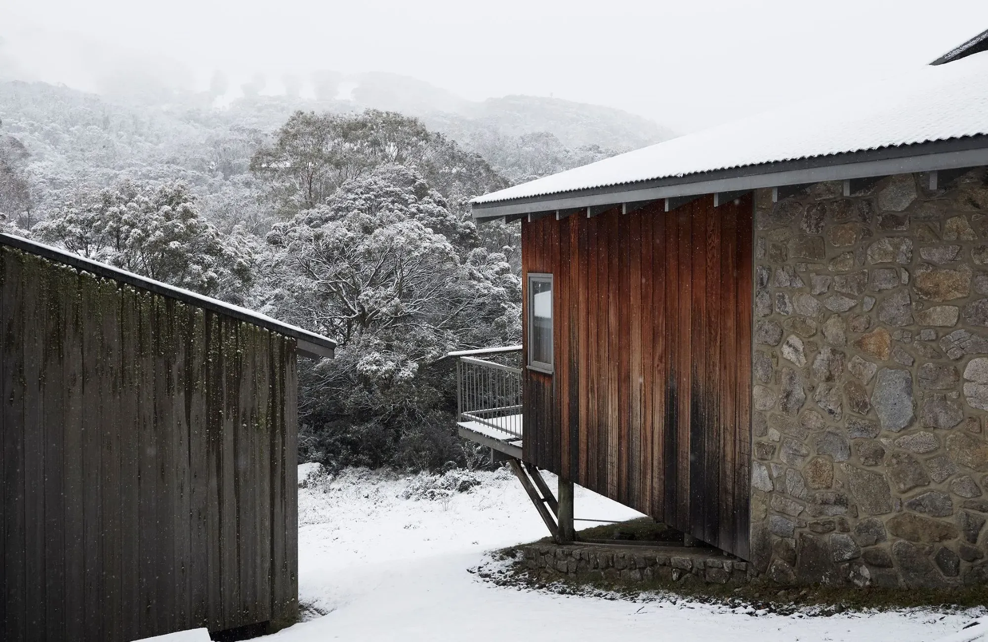 Cedar Cabin by Nicholas Gurney & Monique Easton. Front elevation featuring a snowy winter scene.