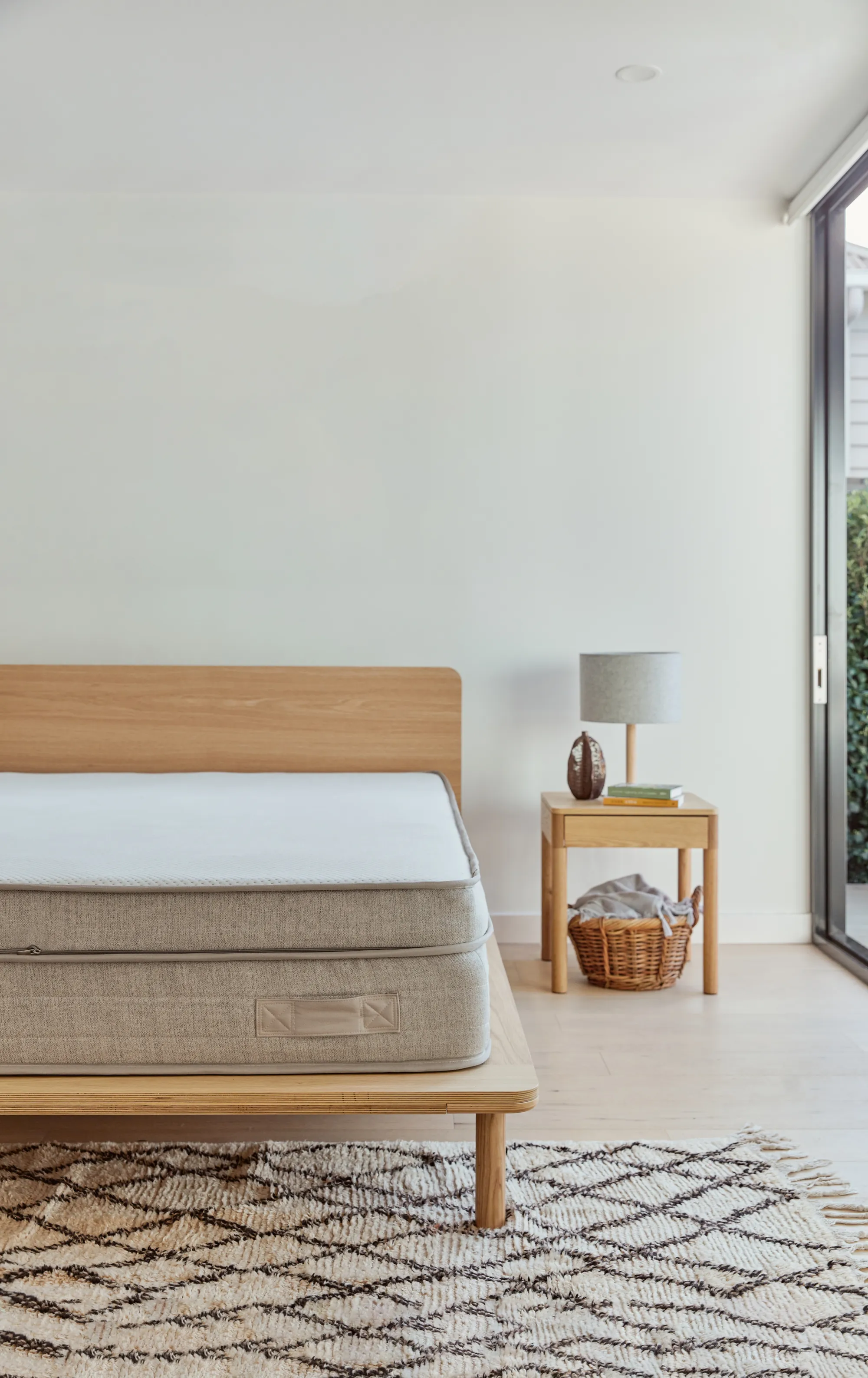 The Premium Adapt Mattress by Eva shown sitting on the Eva bed frame