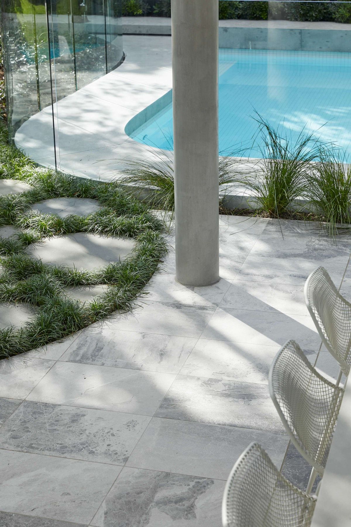 Glen Iris House by Luke Fry Architecture and Interior Design showing the courtyard surface and a glimpse of the pool and landscape