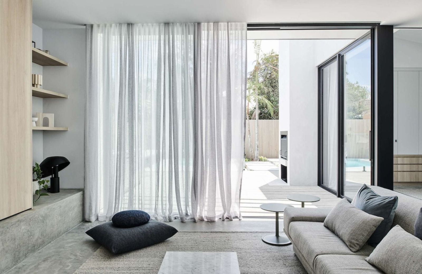 Elsternwick House by Merrylees Architecture & Interior Design. Living room opening up to our door courtyard