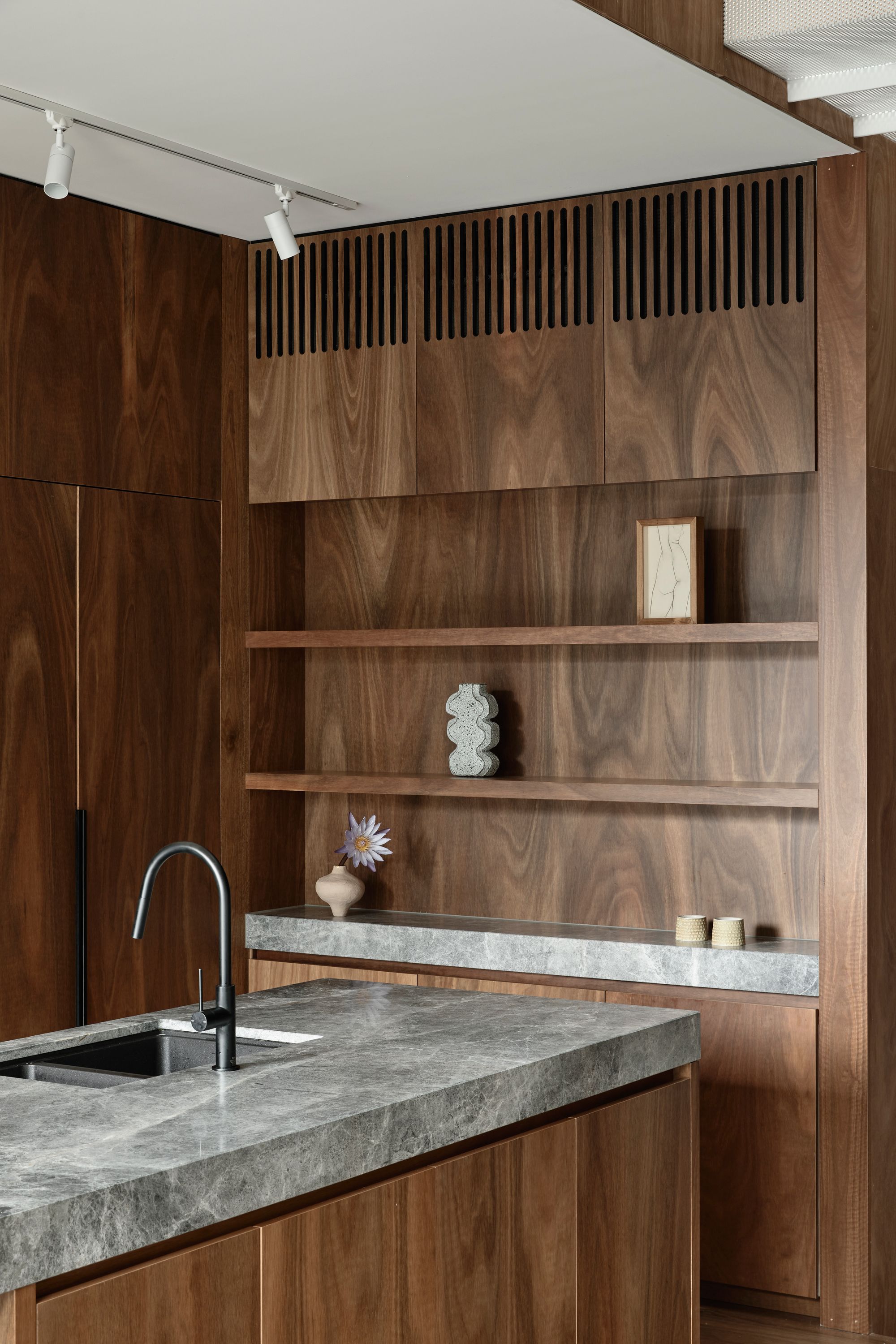 Carlton North Residence by Project 12 Architecture. Detail view of Kitchen, featuring big river joinery & G-lux stone