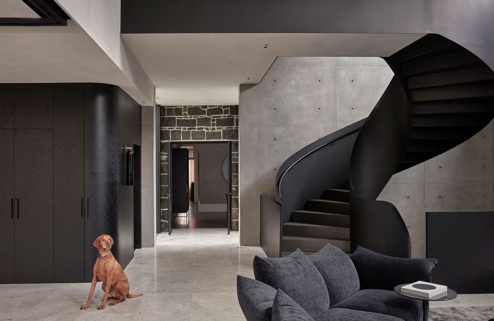 Park House by Pleysier Perkins. Living room, featuring black spiral staircase