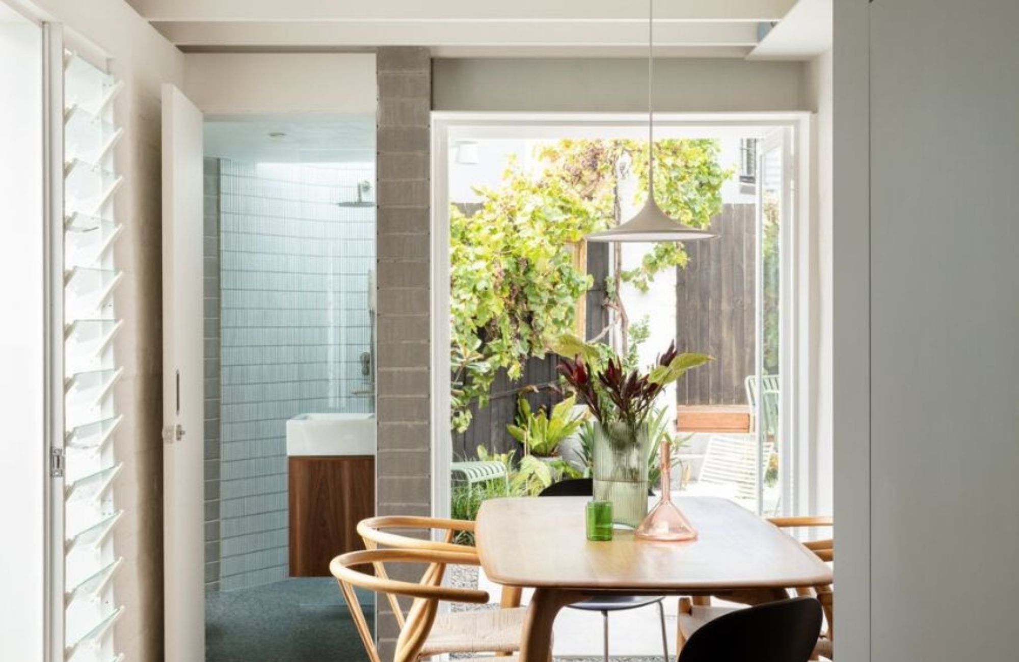 House in Newtown by Architect George. Dining room, view to powder room and outdoors