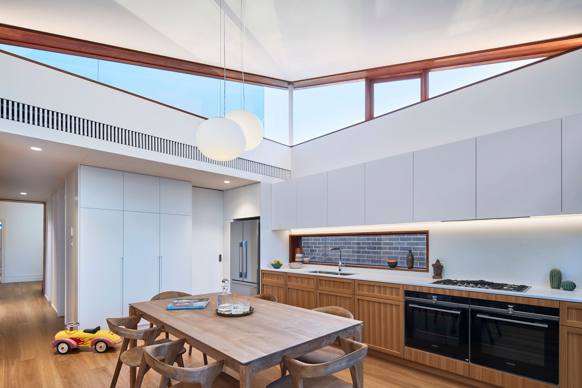 Urban Masseria by Kreis Grennan Architects. Kitchen and dining room featuring yellow toy children's car. 