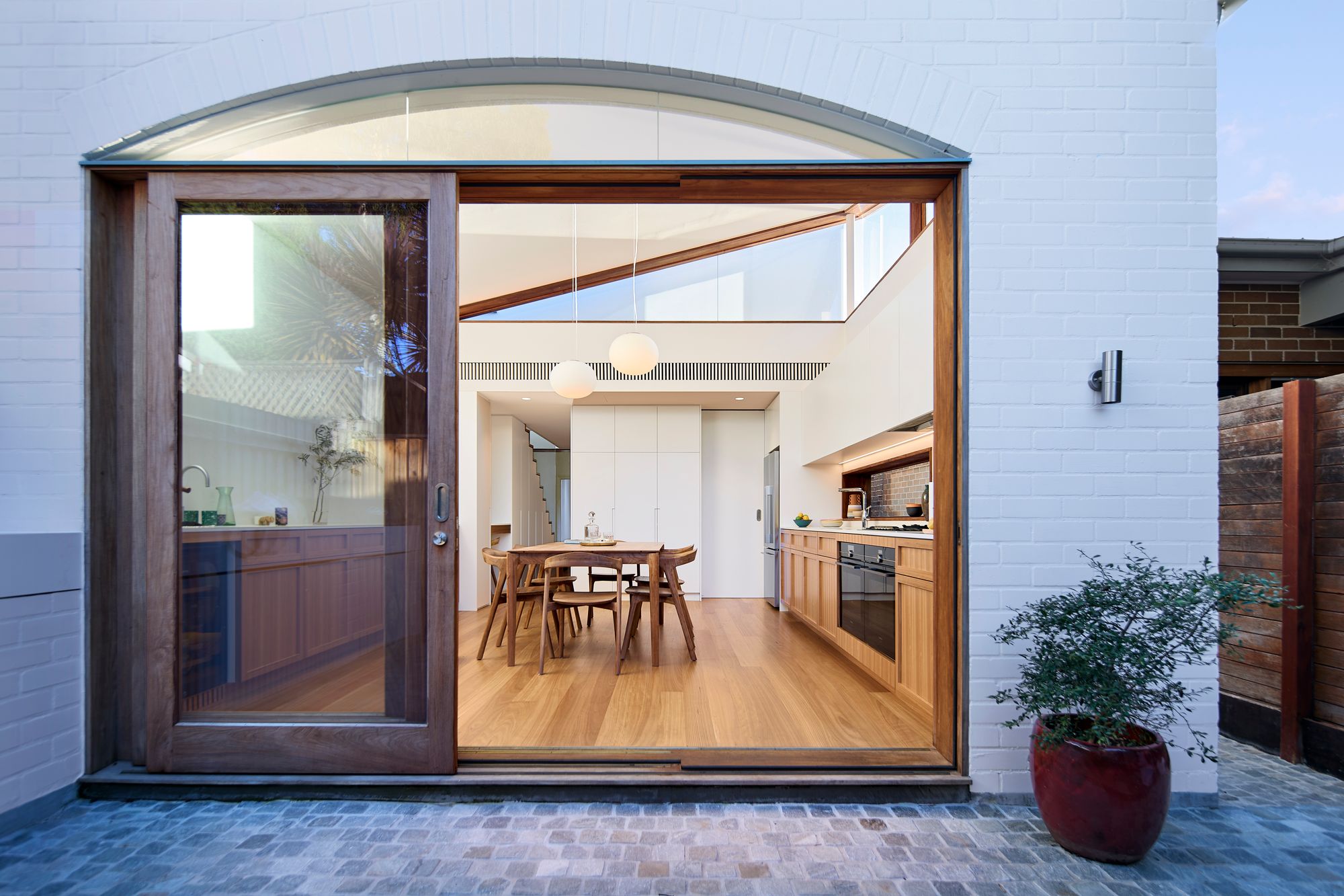 Urban Masseria by Kreis Grennan Architects. View from outdoor courtyard into kitchen and dining. 