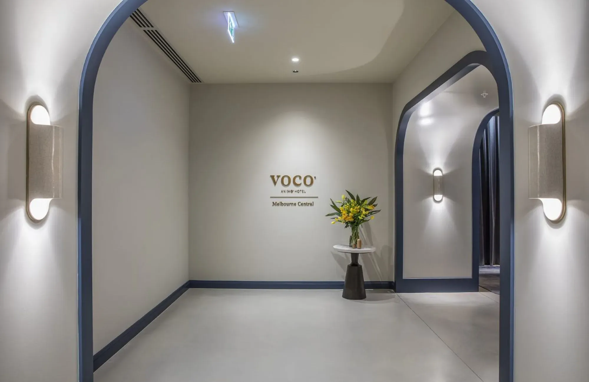Voco Melbourne Central by IHG Hotels & Resorts. Entry foyer, featuring Voco lofo and floral display  