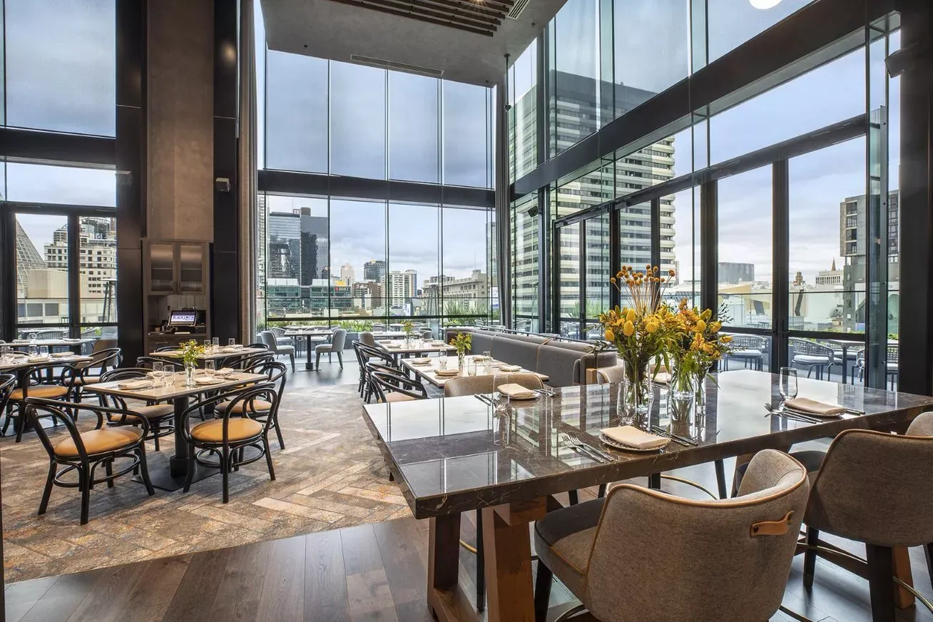Voco Melbourne Central by IHG Hotels & Resorts. Restaurant dining room, window views out to melbourne city
