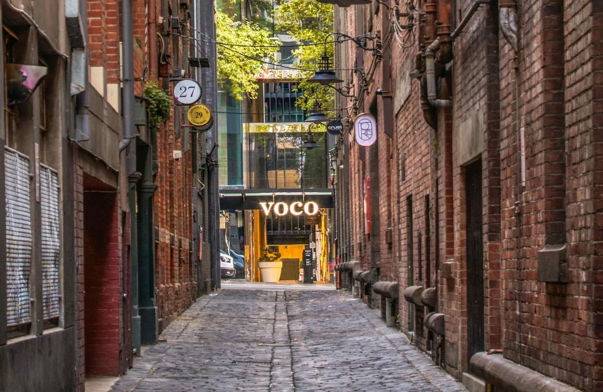 Voco Melbourne Central by IHG Hotels & Resorts. Laneway view, with an emphasis on Voco's logo and facade. 