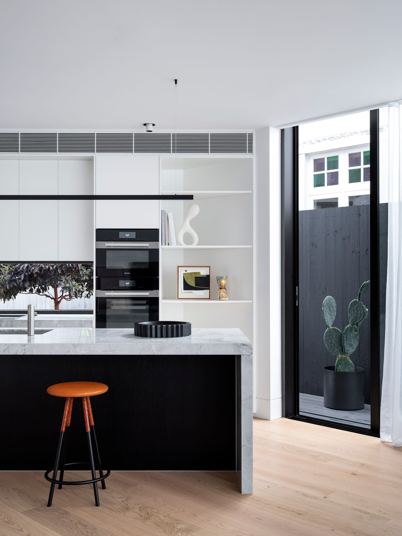 Bondi Beach House by Carla Middleton Architecture. Detailed view of kitchen and island bench seating