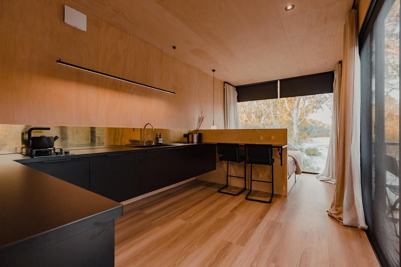 Cortes Cabin by Cortes Stays. Interior of Cabin, featuring window views out to surrounding property