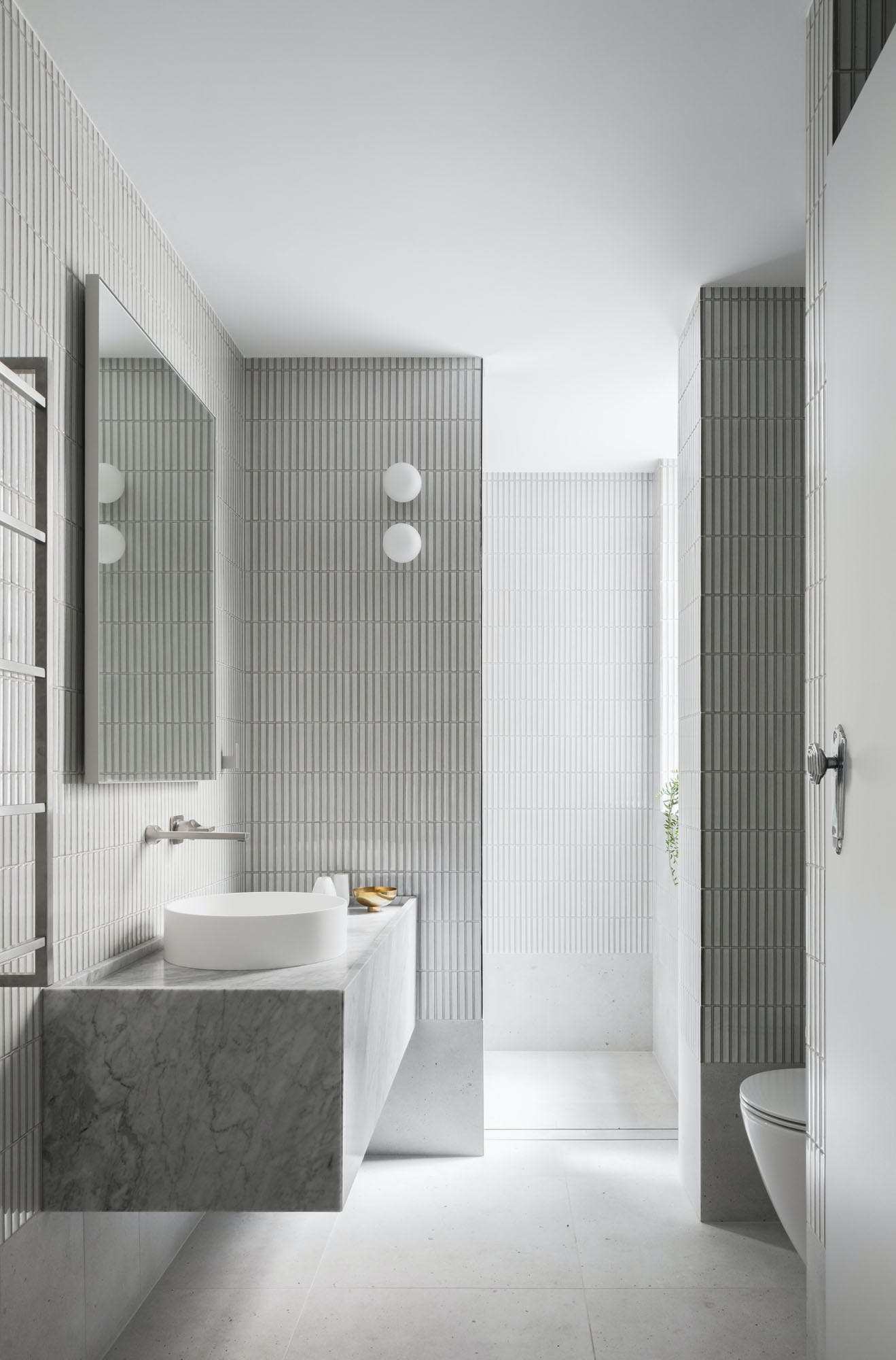 Challis Ave House by Retallack Thompson Architects. Soft minimal bathroom featuring textured vertical tiles. 