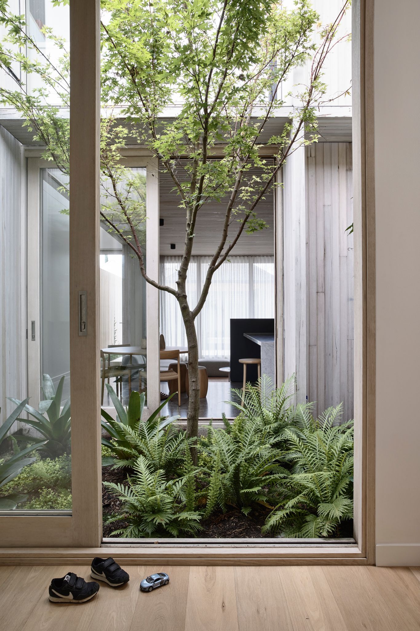 Silvertop House by Tom Robertson Architects. Timber sliding doors opening up to internal courtyard