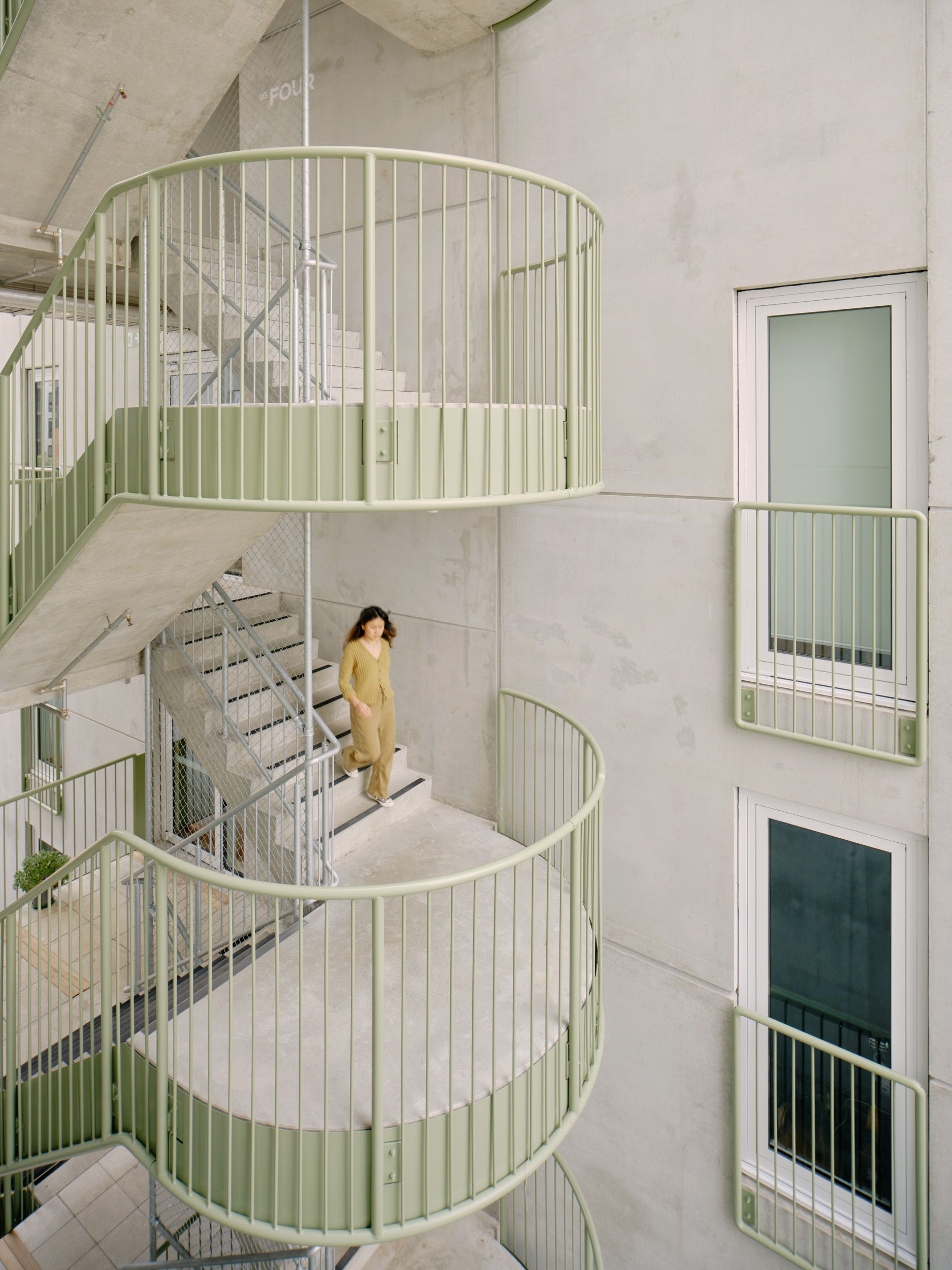 Urban Coup by Architecture architecture and Breathe.  Staircase view featuring duck green accents