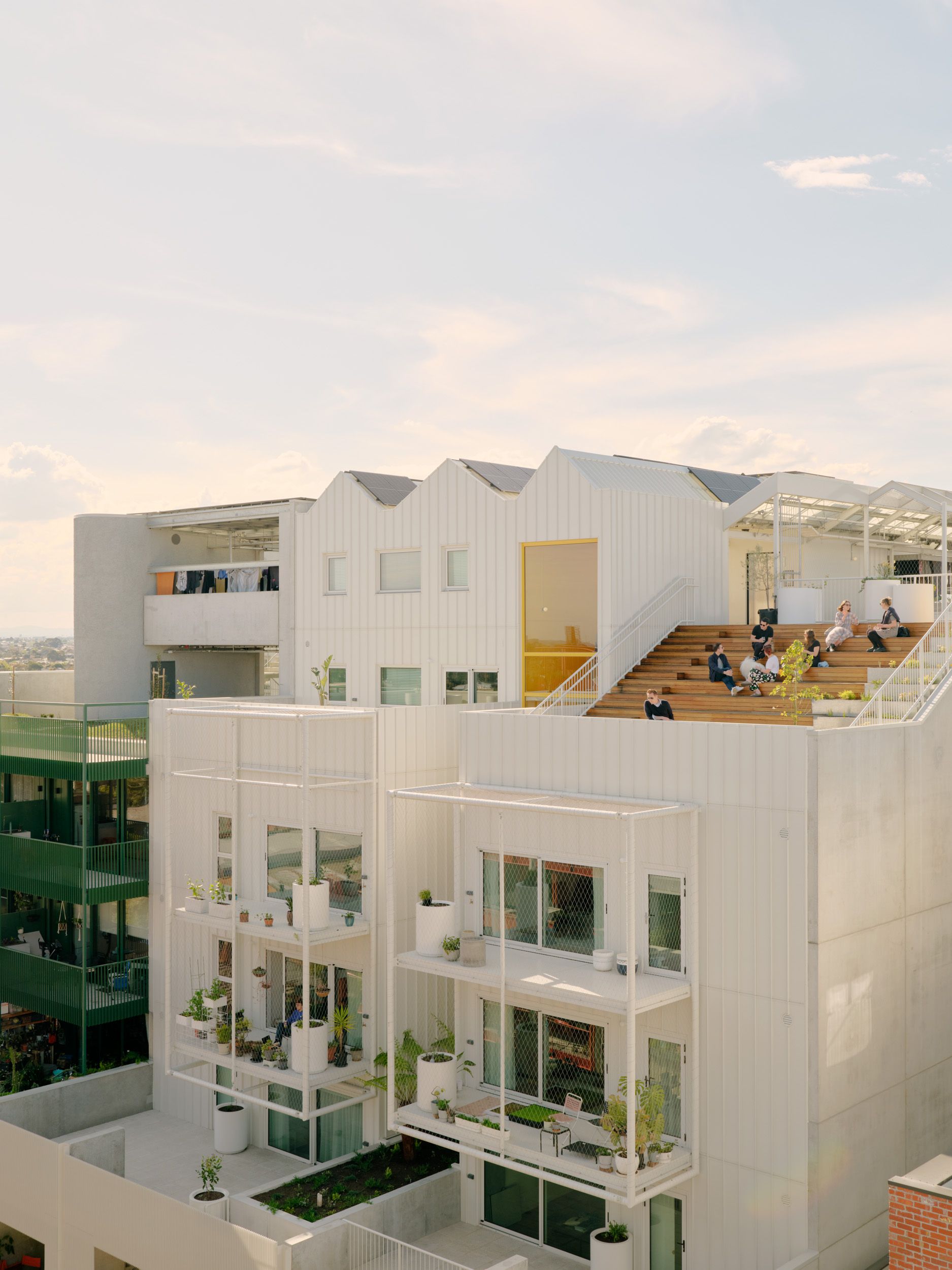 Nightingale ParkLife By Austin Maynard Architects. Birds eyes view of Parklife apartments crisp white facade and yellow accents. 