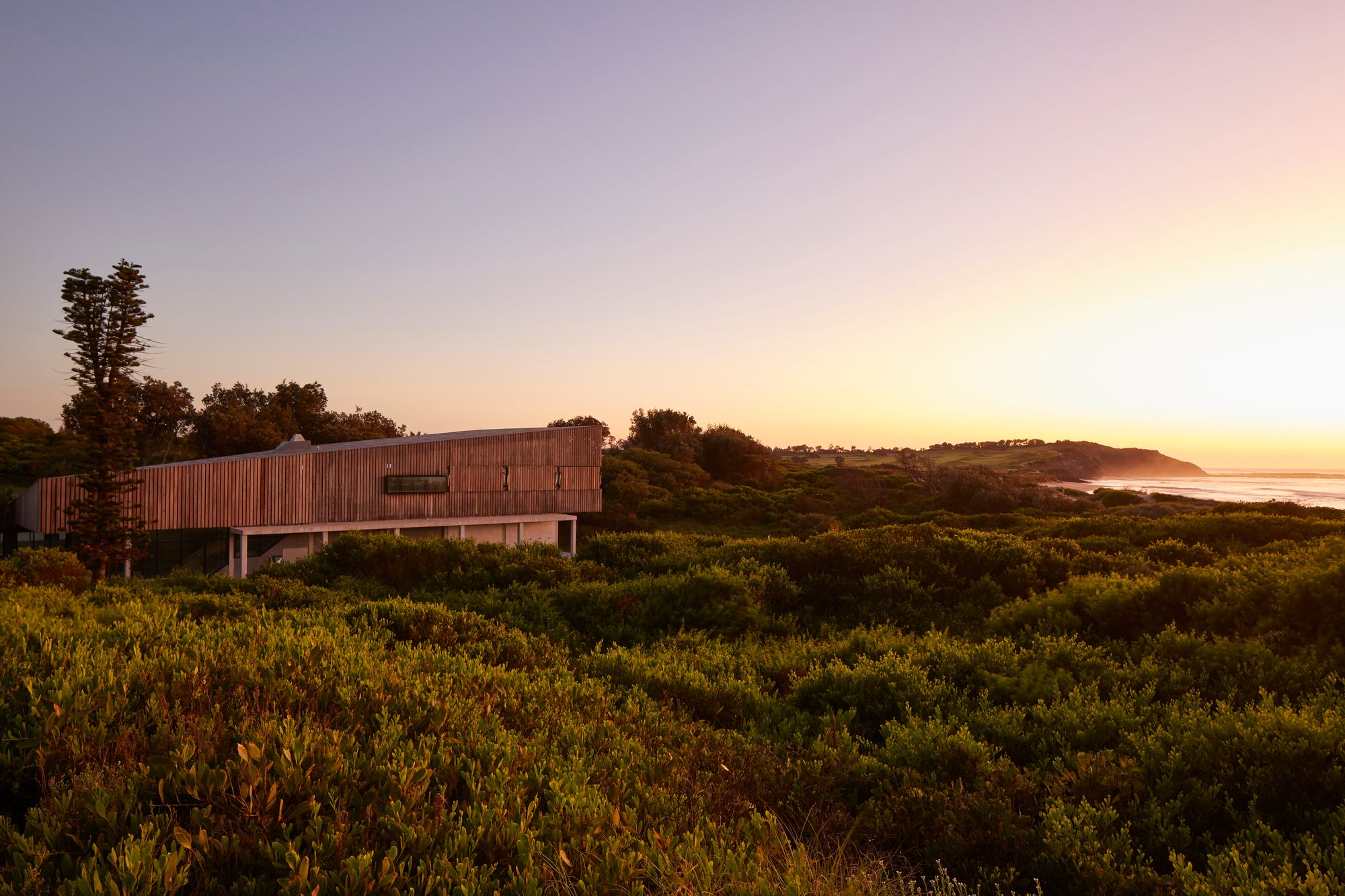 Long Reef SLSC by Adriano Pupilli Architects showing building at sunrise