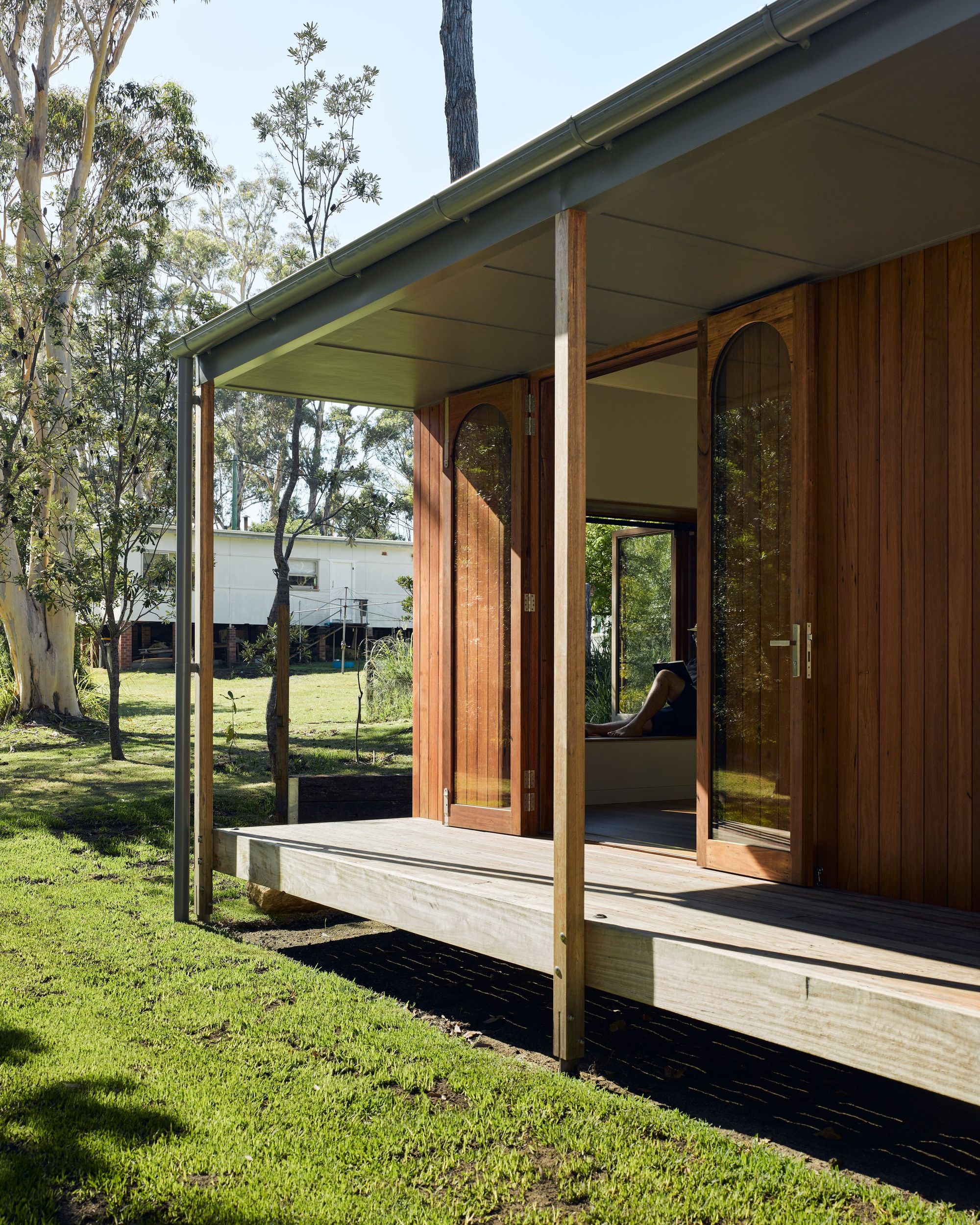 Re-Generation House by Alexander Symes Architect showing timber deck and timber doors