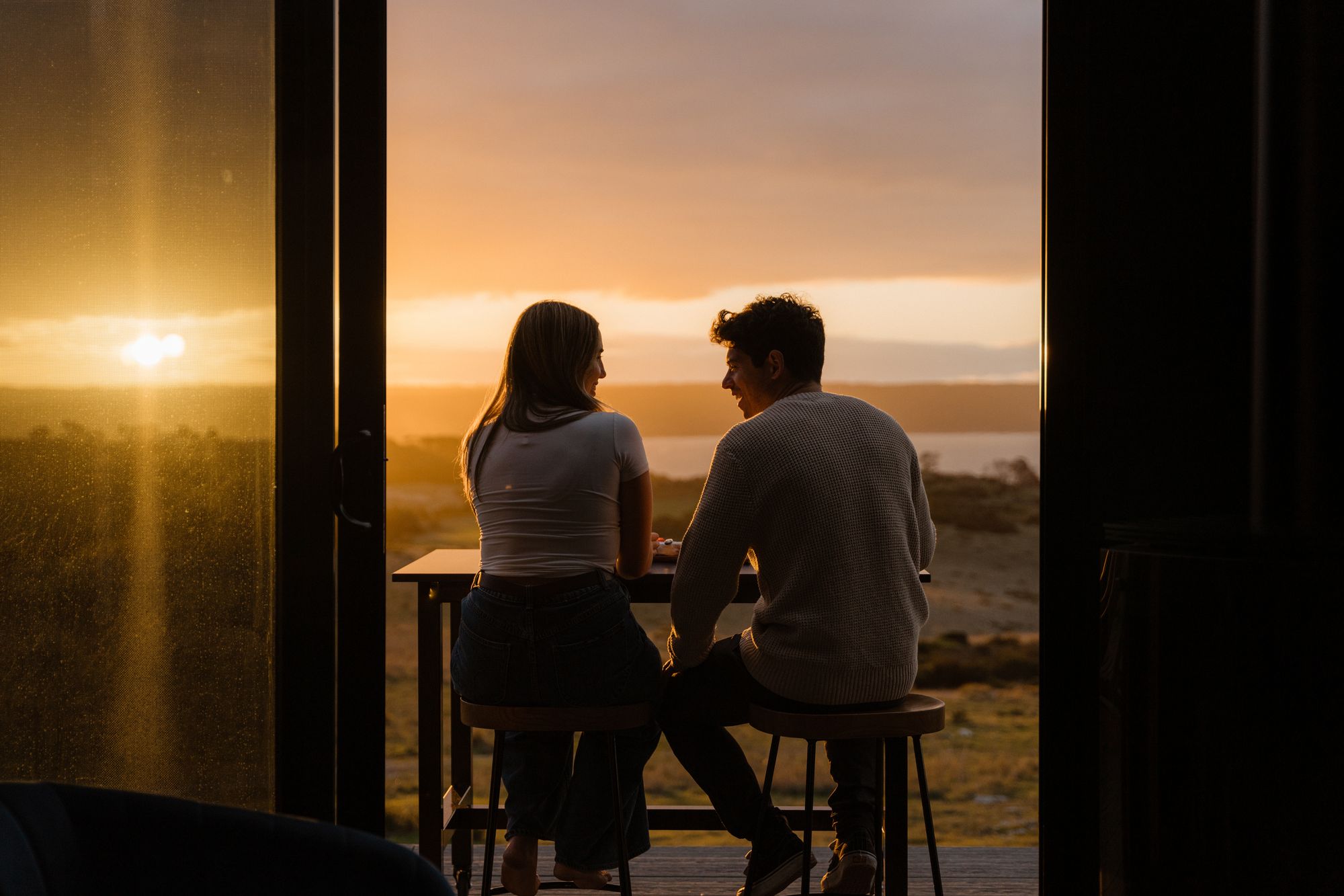 CABN X Cape St Albans. View from cabin out to deck, during sunset. 