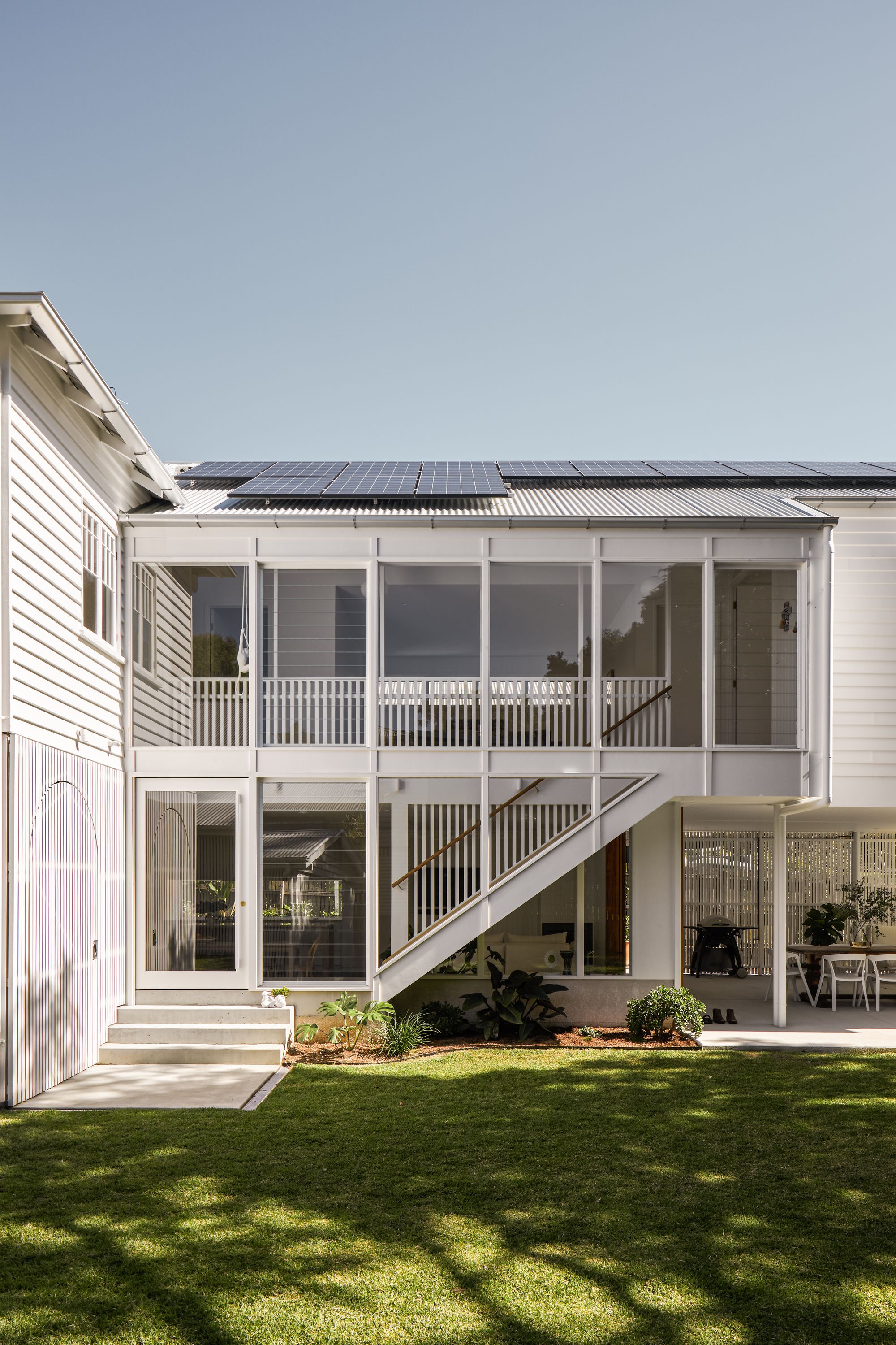 Fuller Street Cottage by DAH Architecture showing exterior view and backyard