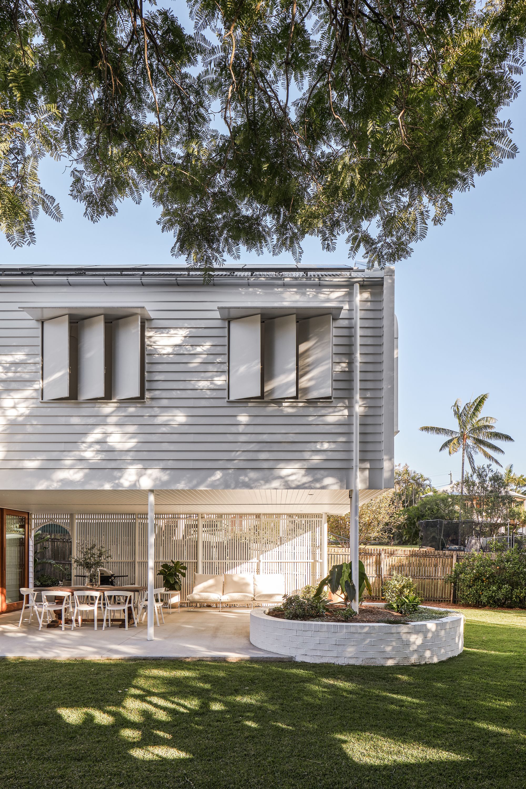 Fuller Street Cottage by DAH Architecture showing external courtyard and weatherboard house