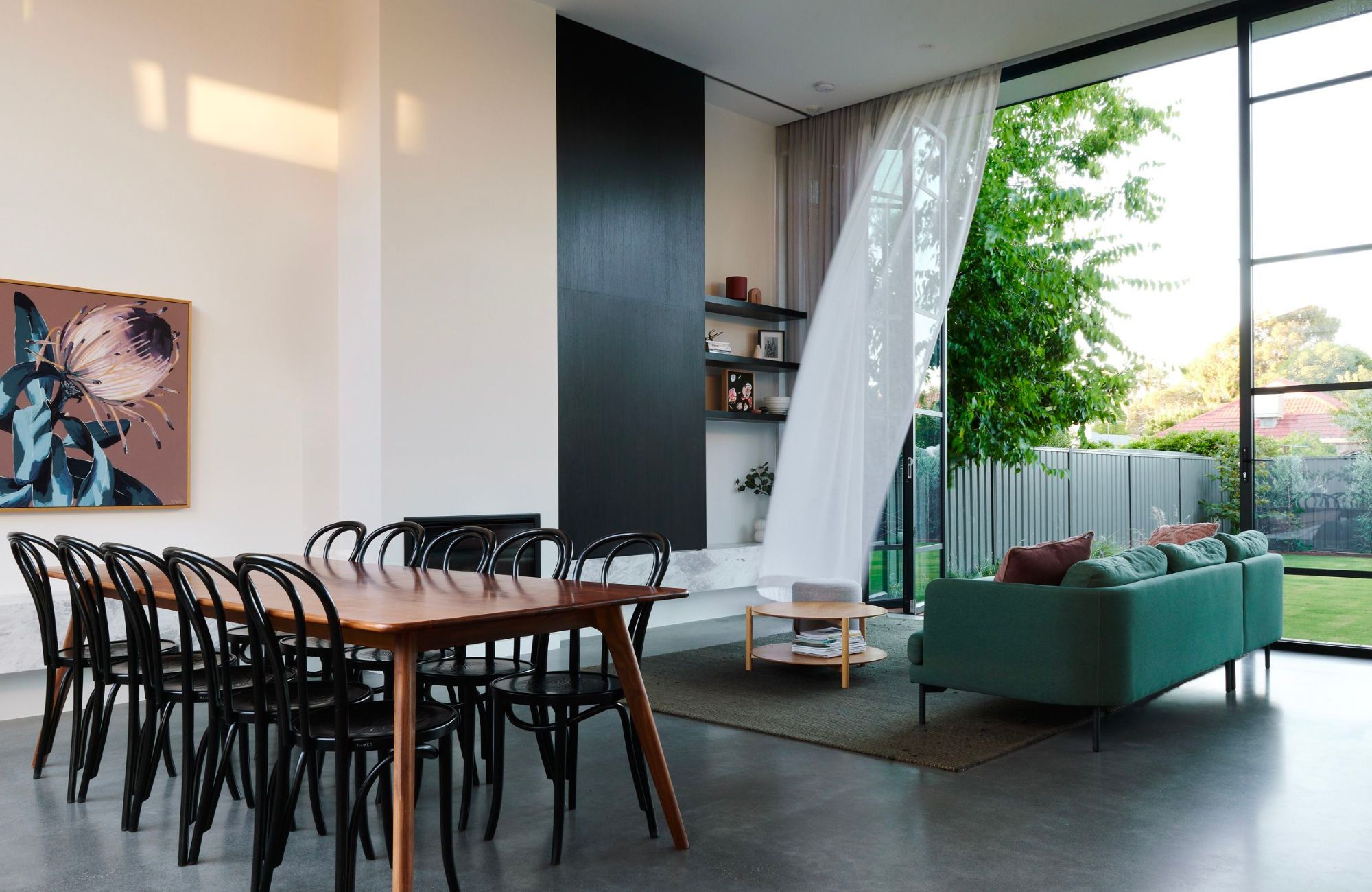 Garden House by Atelier Bond showing interior of the dining and living space looking out to the backyard