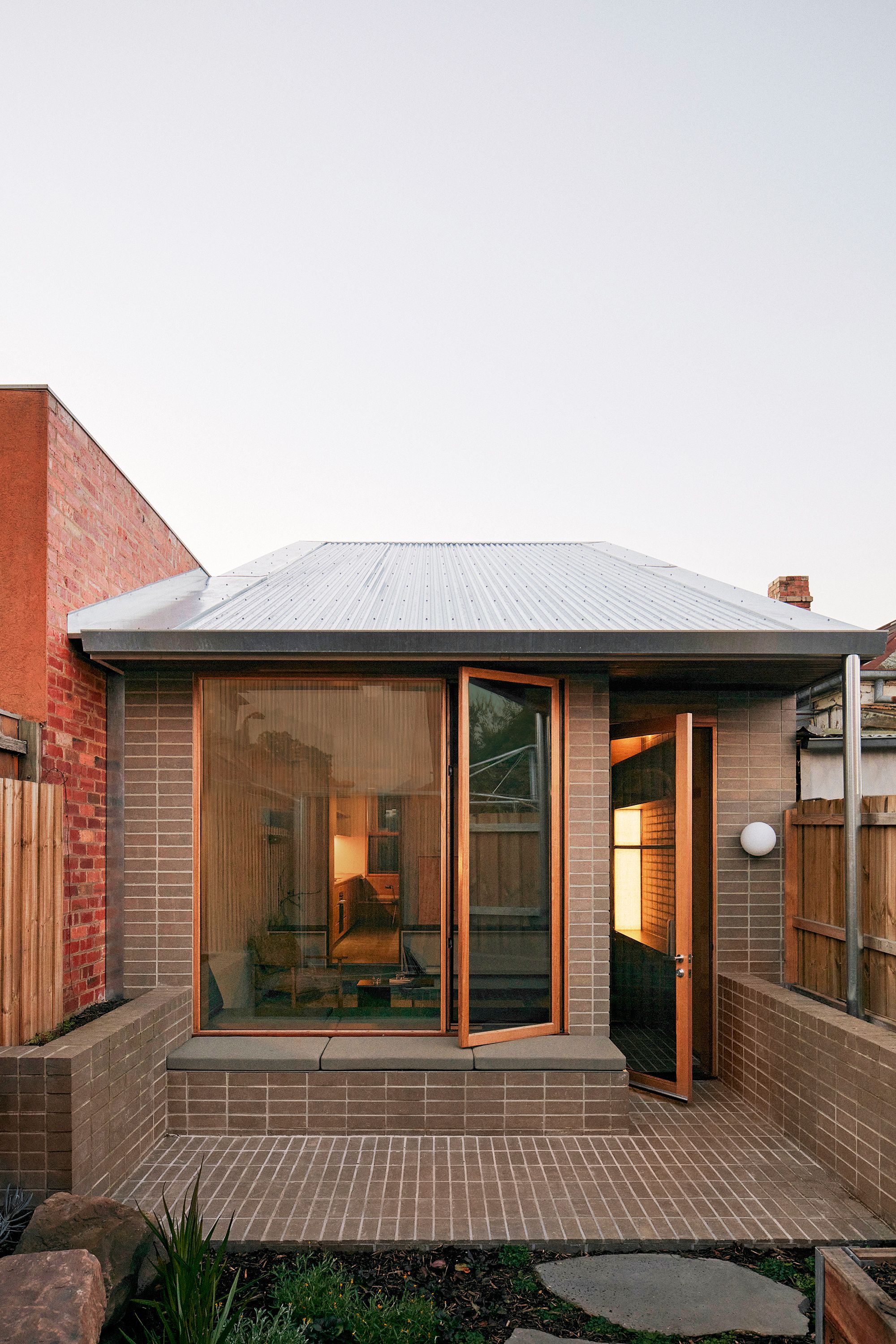 Brunswick by Placement Studio showing brick courtyard with window seat
