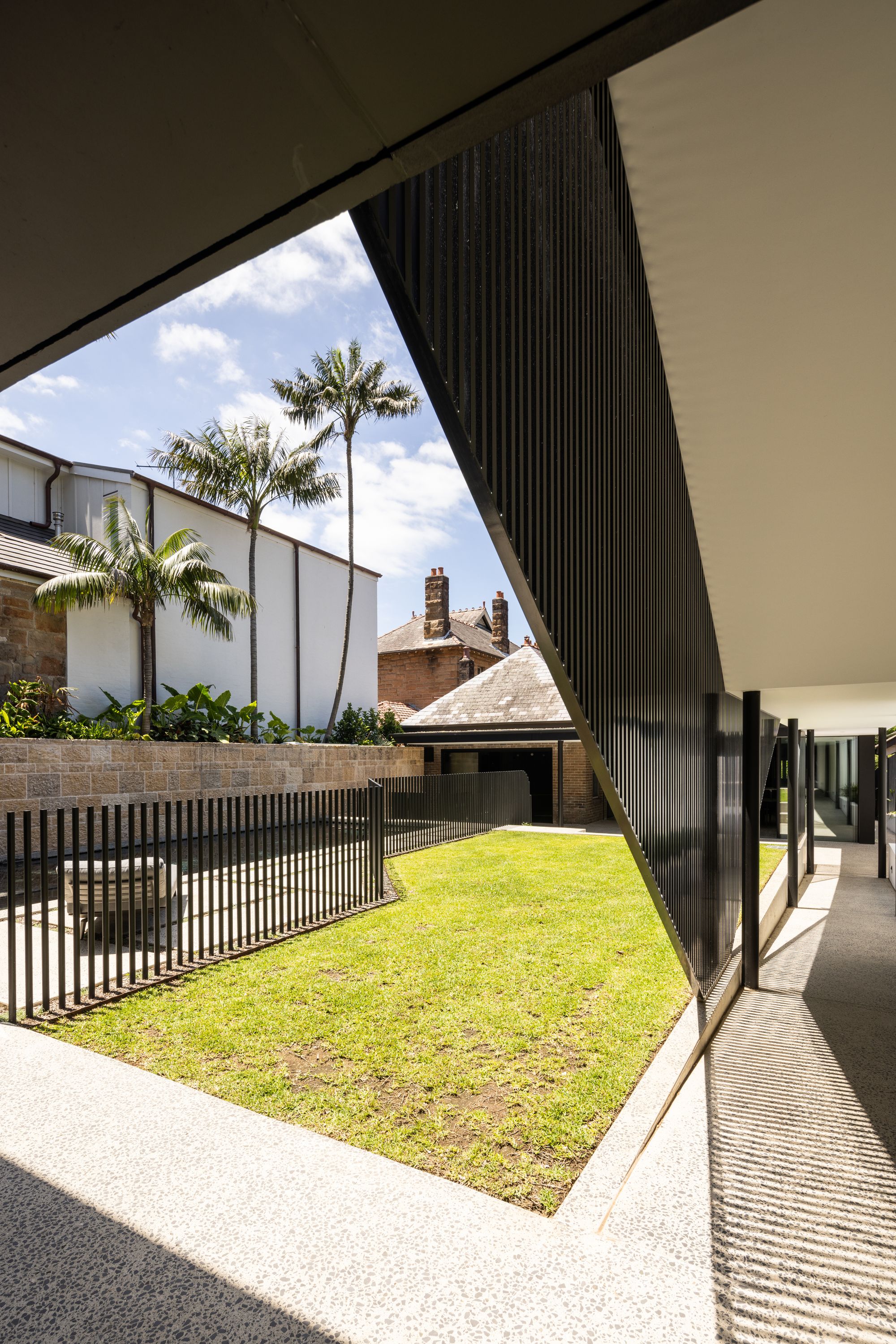 Tongkah by MCK Architects. View from exterior corridor out to shared outdoor garden. 