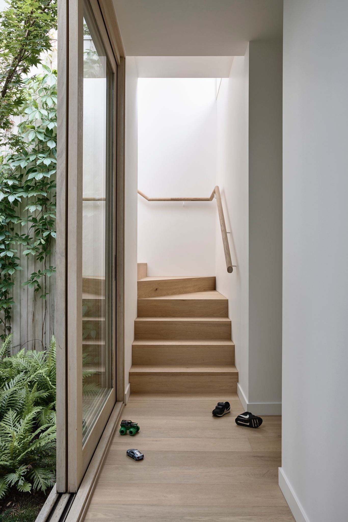 Silvertop House by Tom Robertson Architects. Stairs leading to second level.