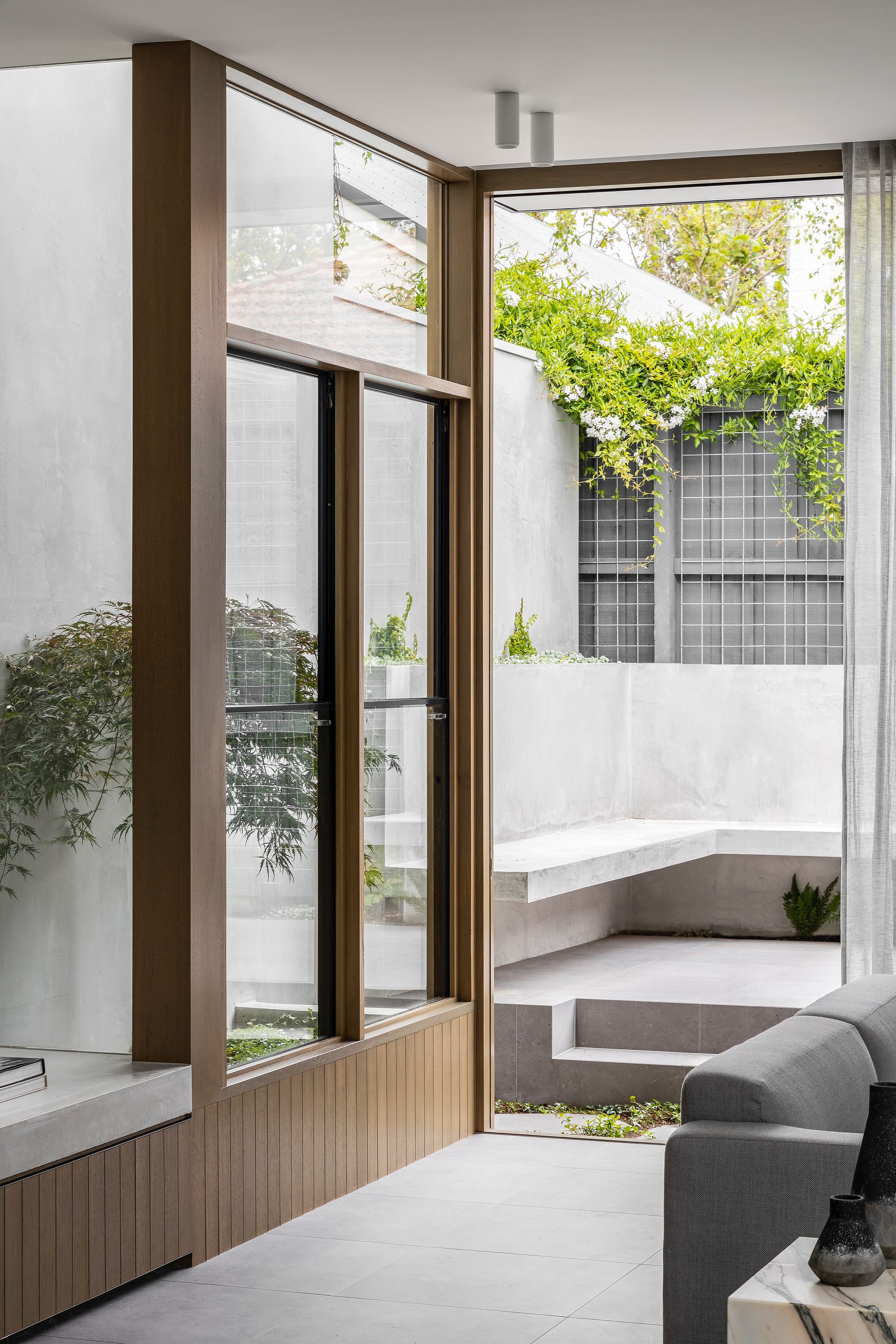 Ripponlea House by Luke Fry Architecture & Interior Design showing view out to tiled courtyard with concrete bench seat