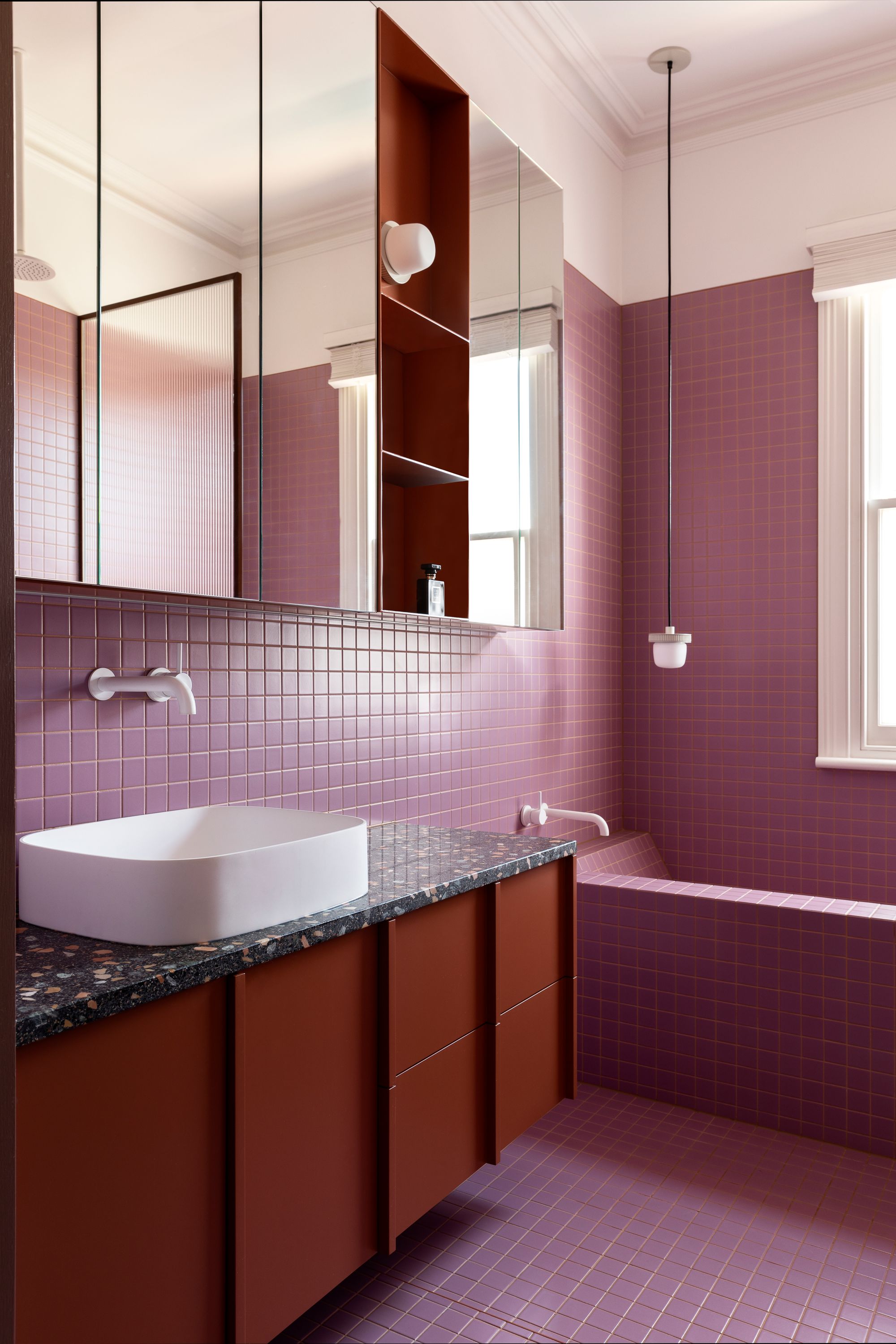 Herman by Wowowa Architecture.  Bright and bold pink and burgundy bathroom with terrazzo feature basin