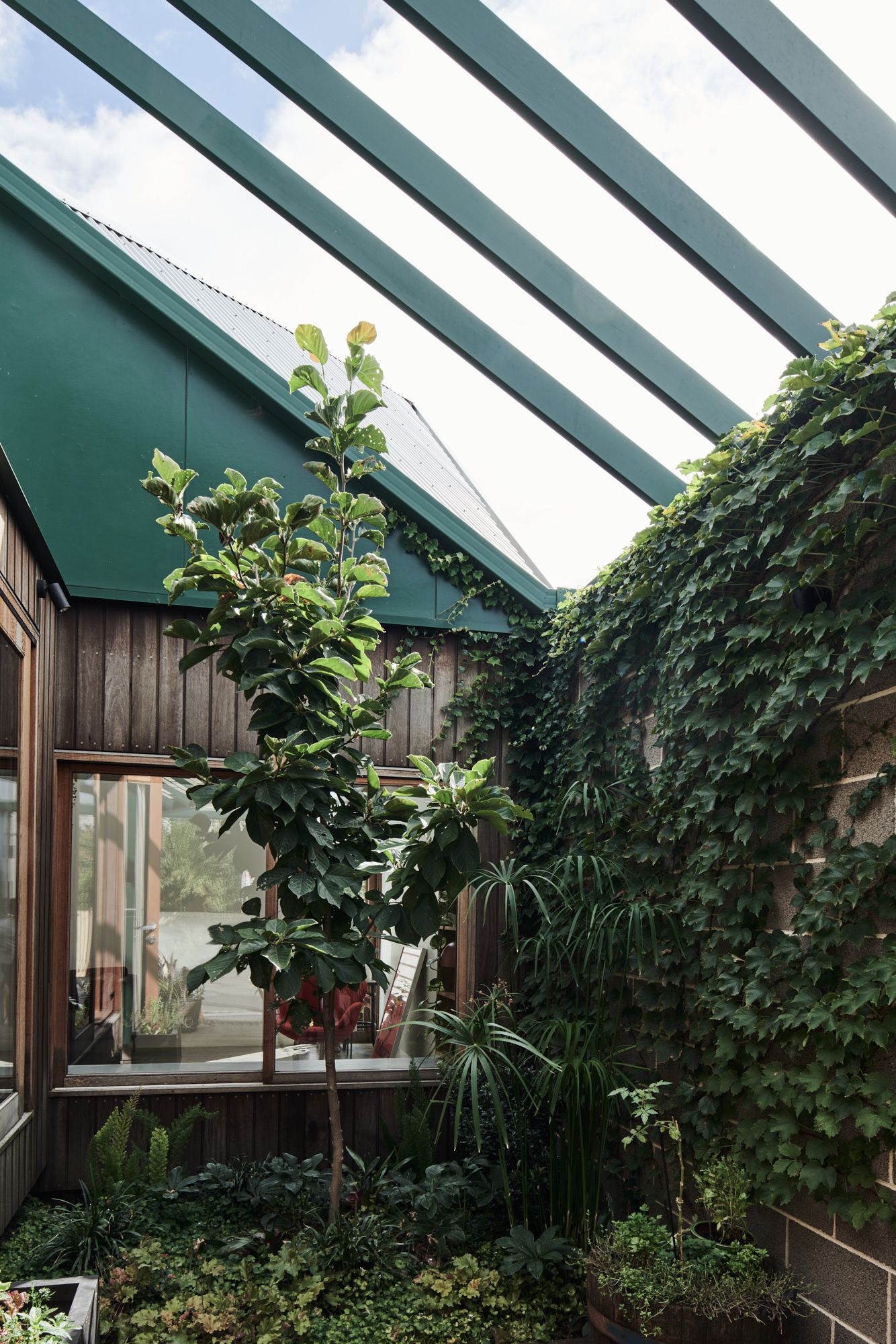 Hot Top Peak by FIGR Architecture. Courtyard view with windows viewing inside 