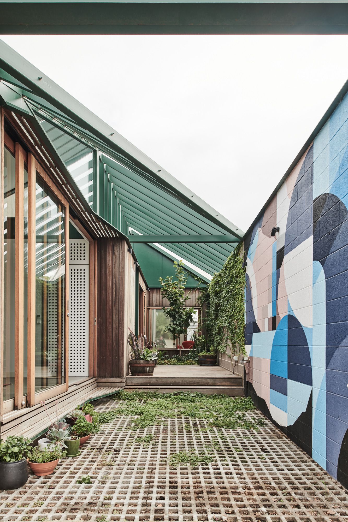 Hot Top Peak by FIGR Architecture. Courtyard view featuring mural 