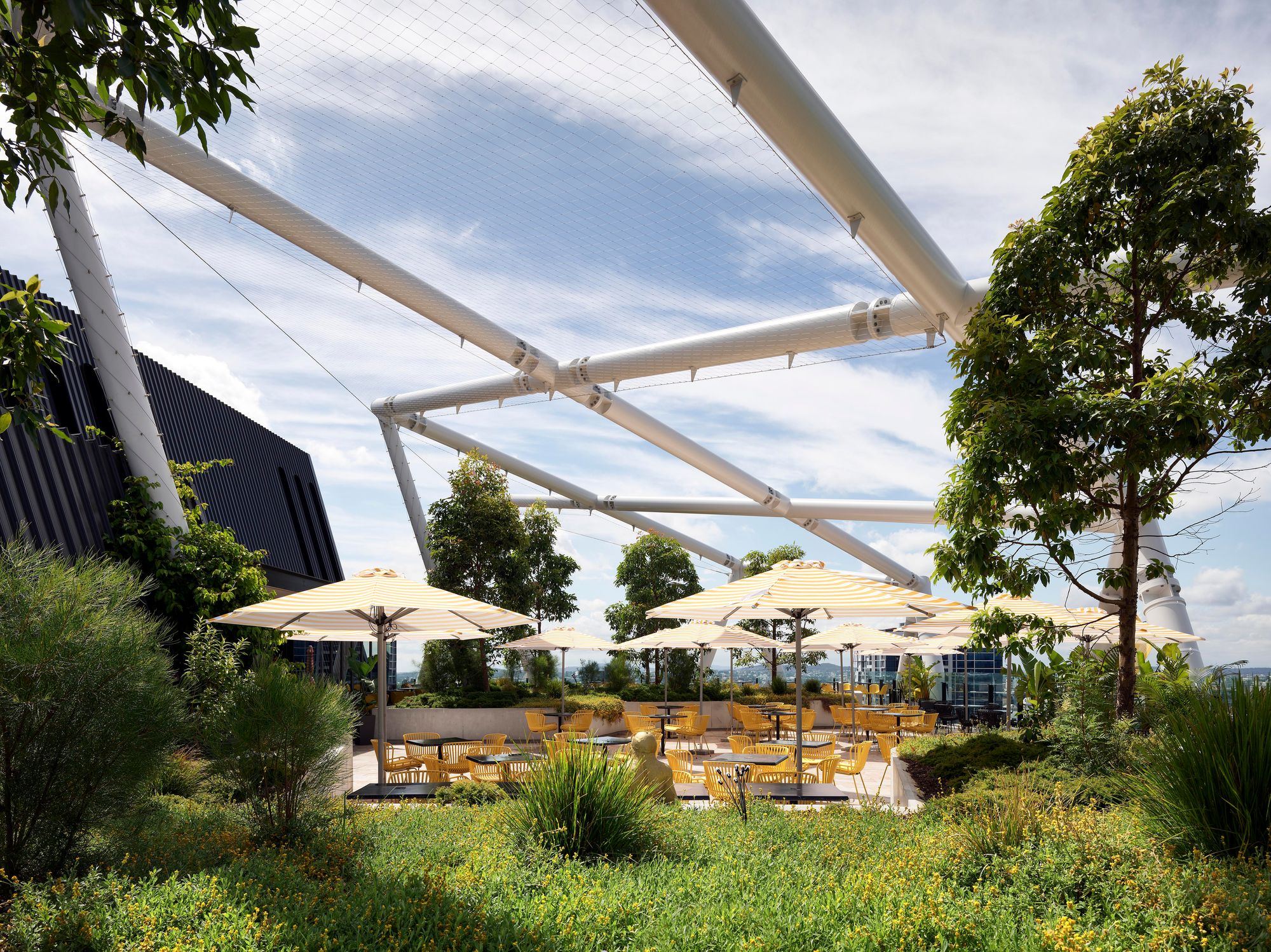 Jubilee Place and Hotel by WILDStudio showing outdoor dining on the roof garden