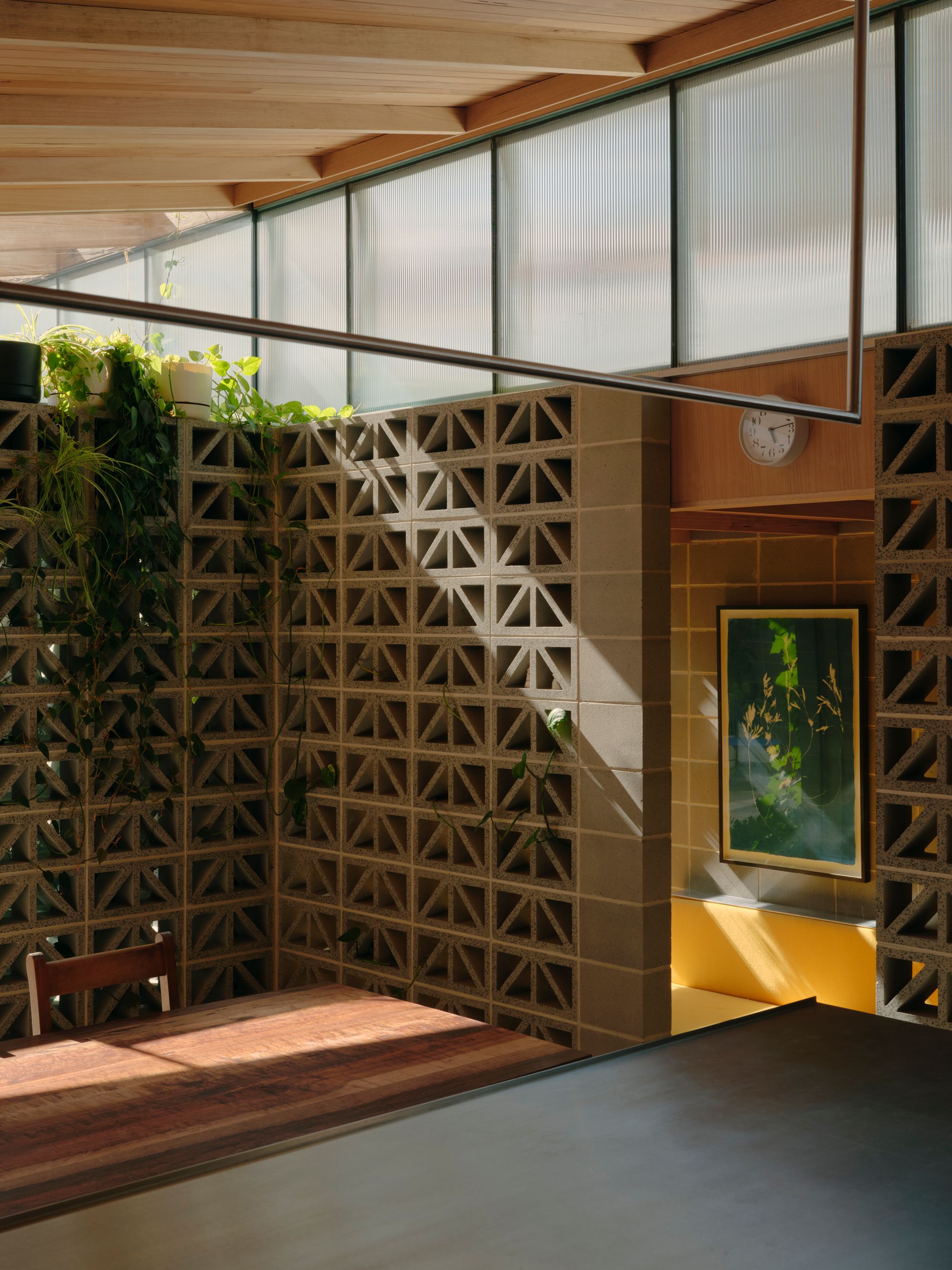 Sunday by Architecture architecture. View from kitchen and dining room, surrounded by breeze block, and hints on sunny yellow. 