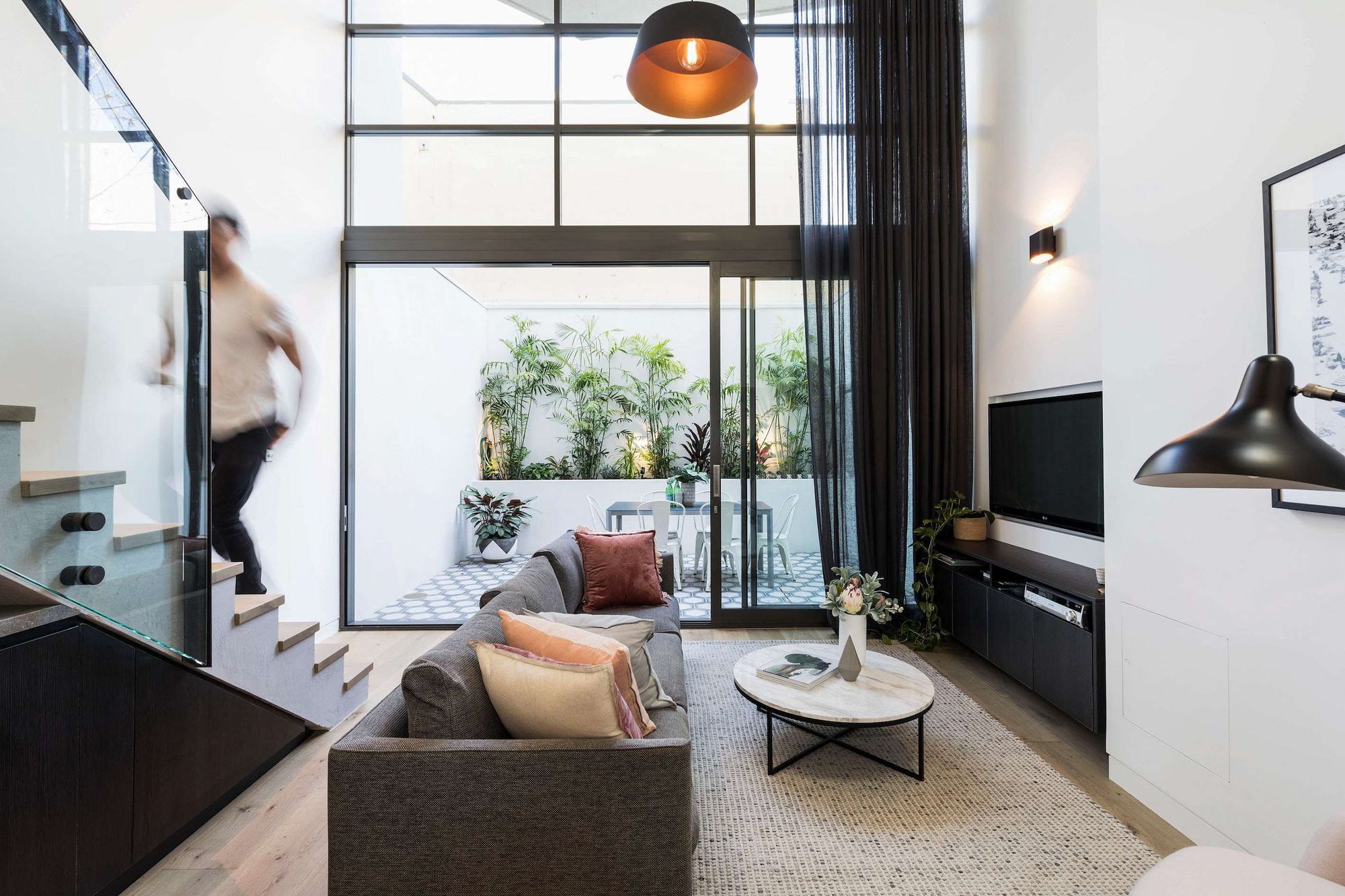 Darlinghurst Residence by JKMarchitects showing living room space looking out to courtyard