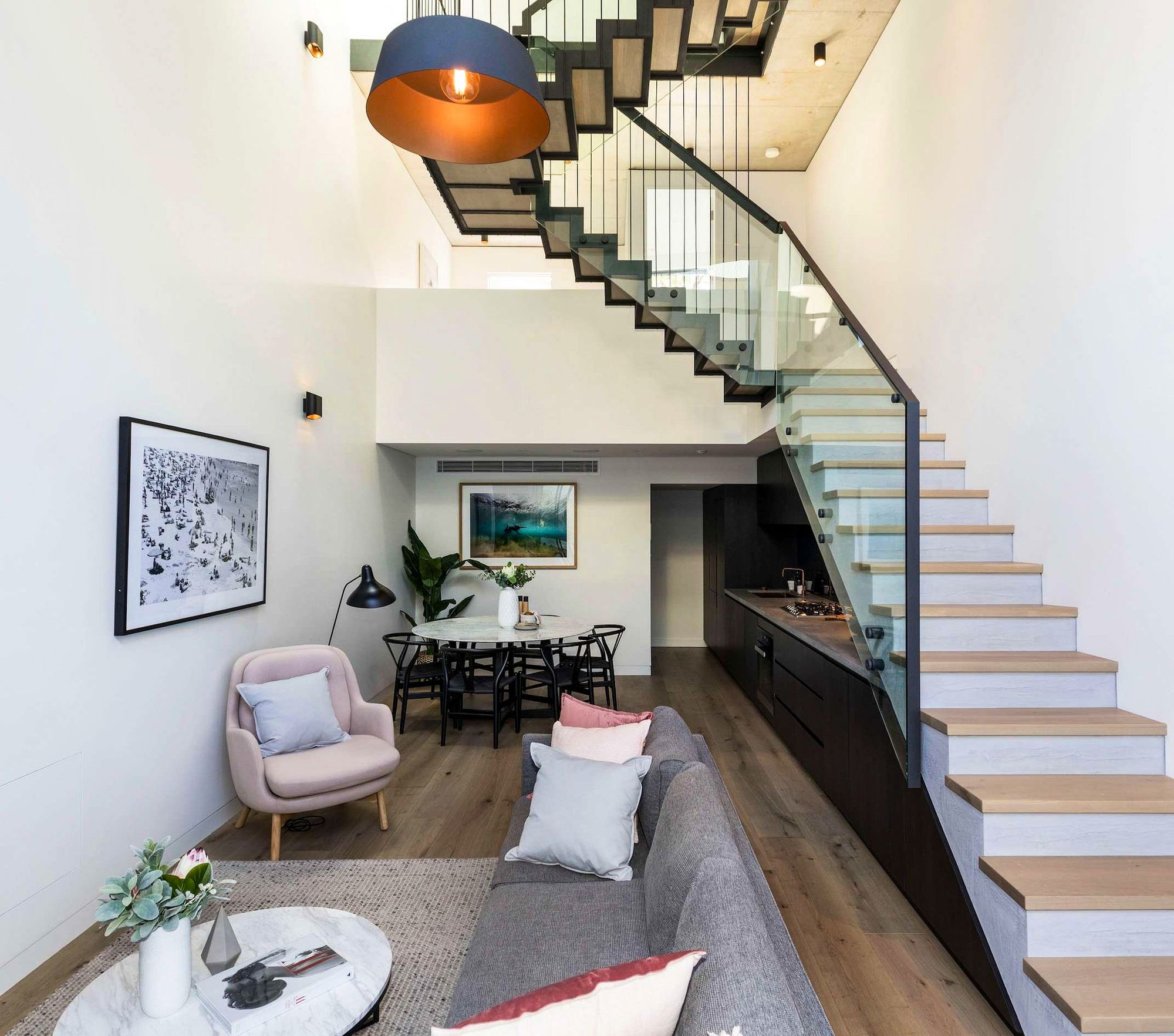 Darlinghurst Residence by JKMarchitects showing internal view of living area and feature staircase