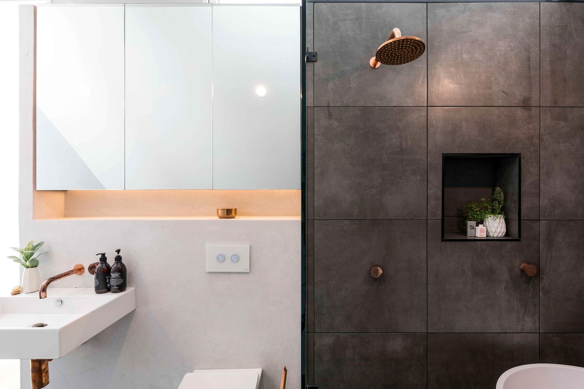 Darlinghurst Residence by JKMarchitects showing bathroom elevation of dark and light tiles