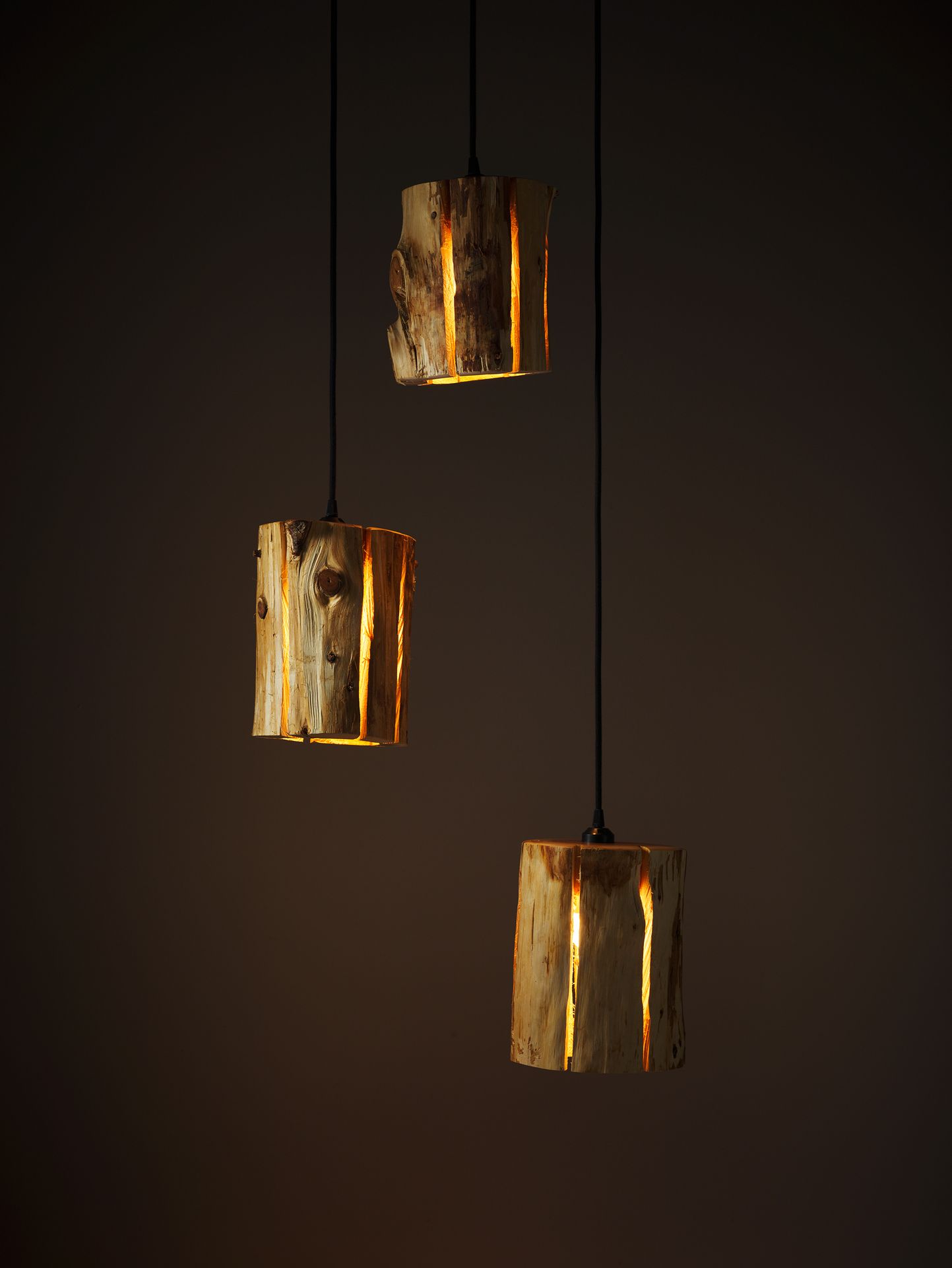 Duncan Meerding's Cracked Log Pendants in a serries of three hanging at various heights