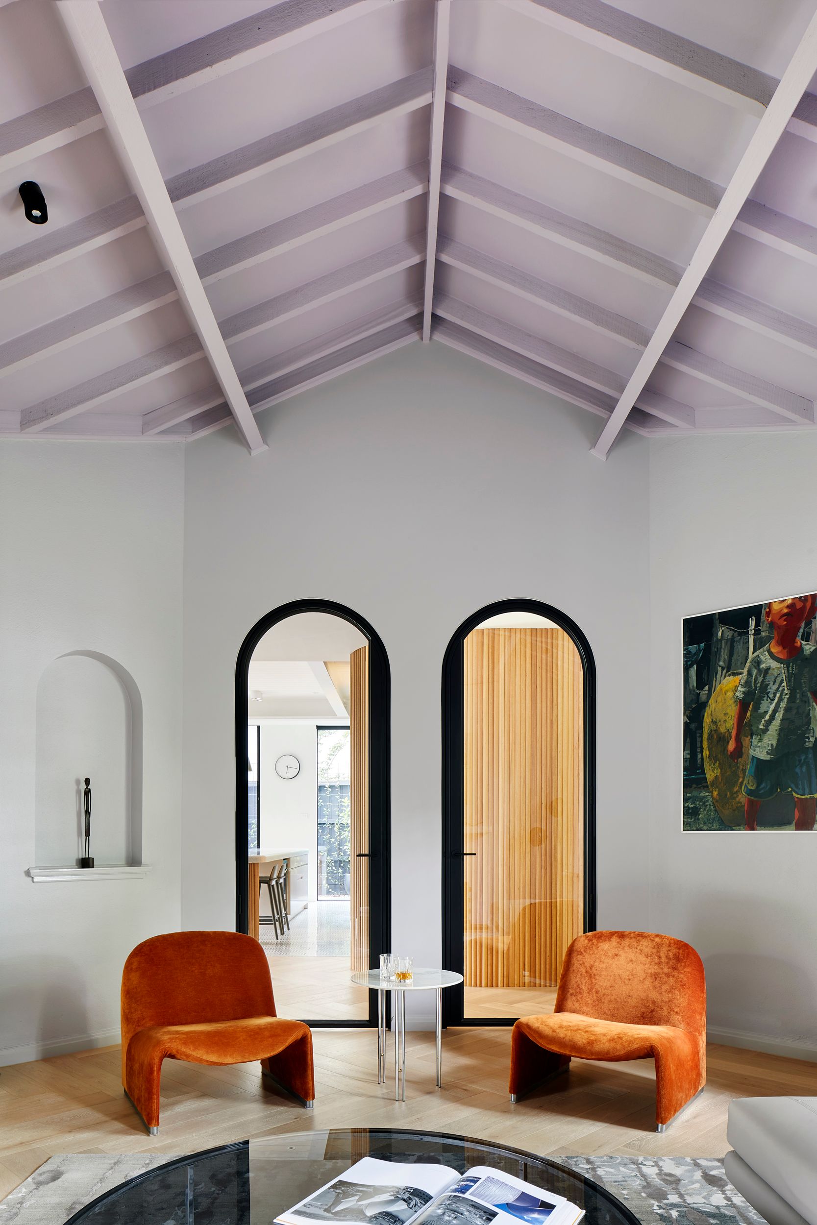 Arch Deco by Hindley & Co.  Arch deco project of Formal Living room space featuring two accent orange chairs. 