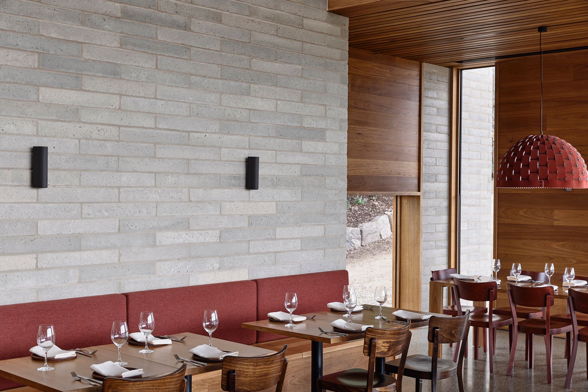 Delatite Cellar Door by Lucy Clemenger Architects. Detailed view of restaurant, featuring warm colour palette. 