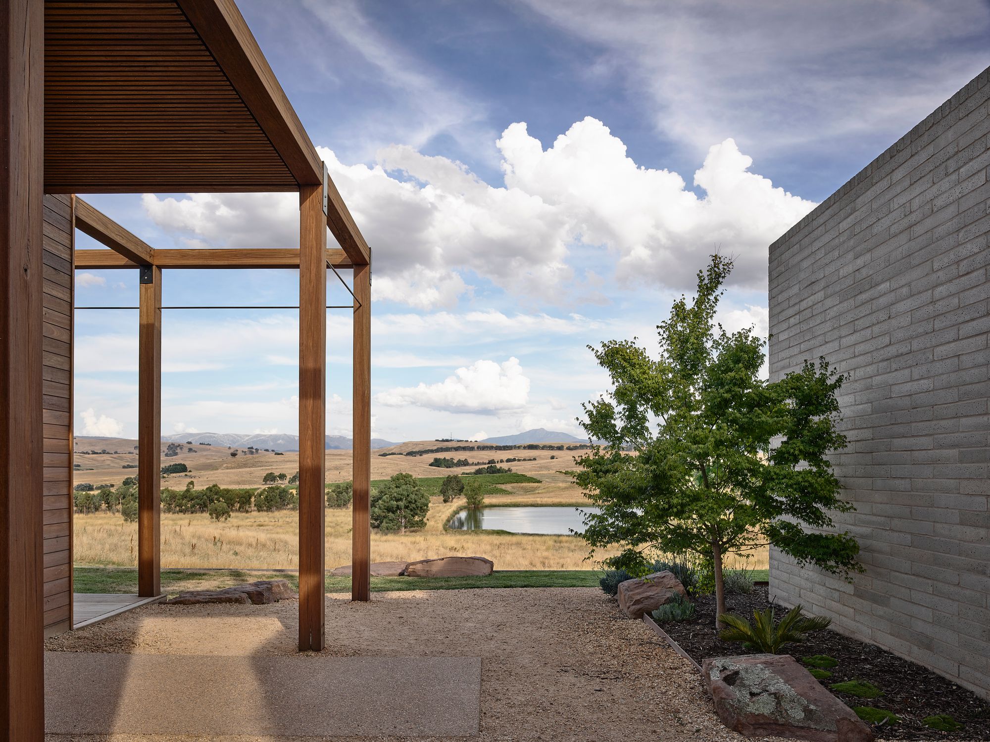 Delatite Cellar Door by Lucy Clemenger Architects. View within Coutyard looking out to rolling hills, and vineyards. 
