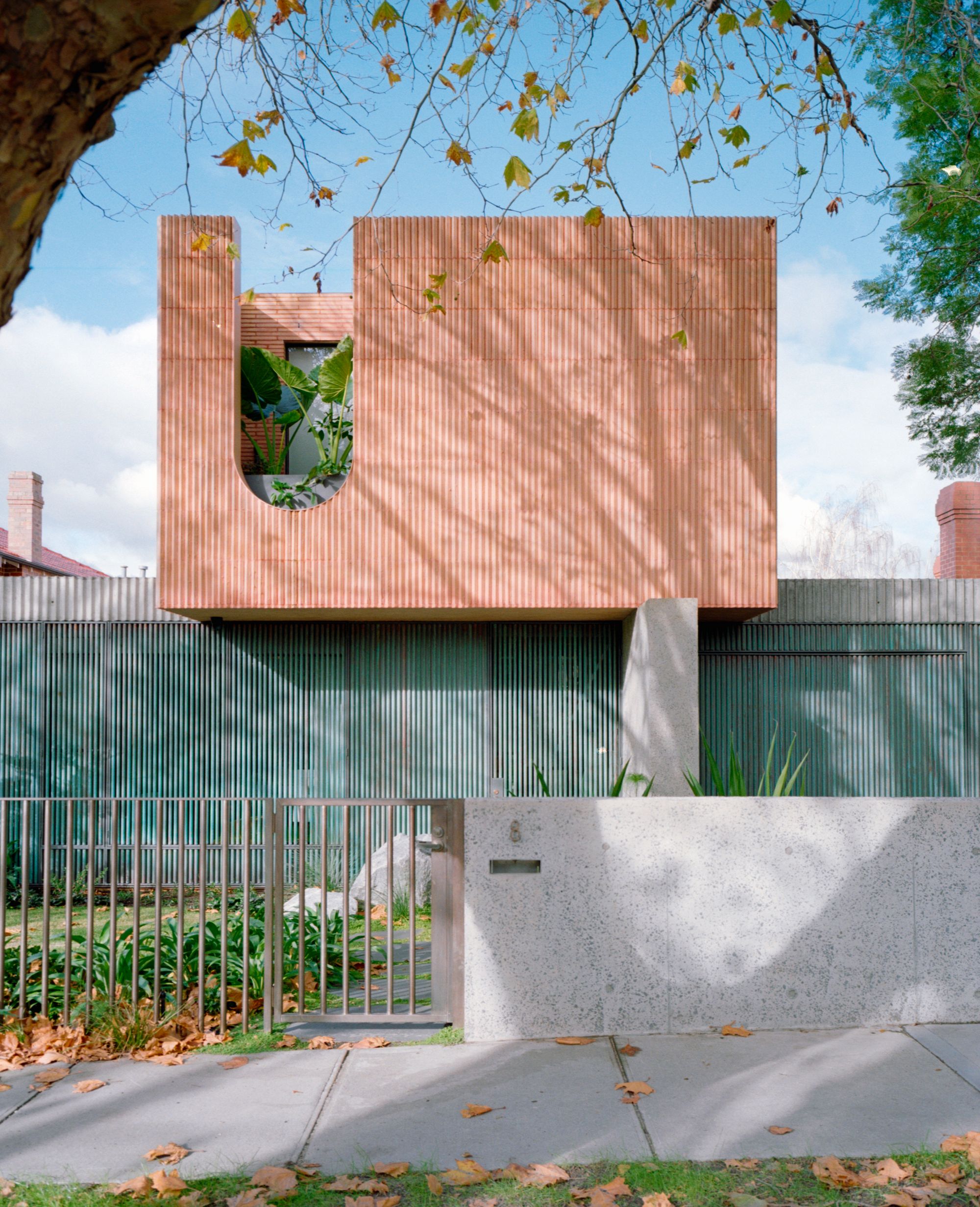 Glen Iris House by Pandolfini Architects. Front façade of house pictured, subtle tones of salmon and tea.