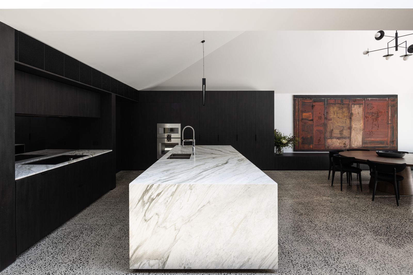 A kitchen with cabinets and a bathroom with fixtures