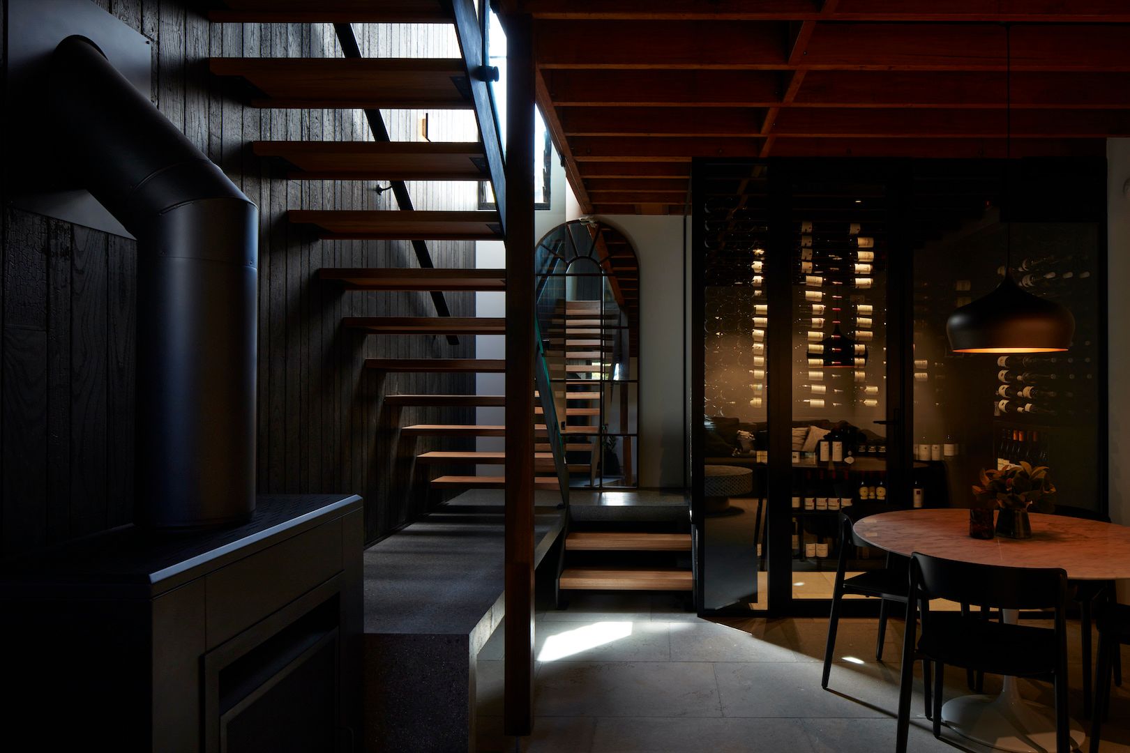 The Pavilion Castlecrag by McNally Architects. View into dining, wine cellar and staircase up to second level. 
