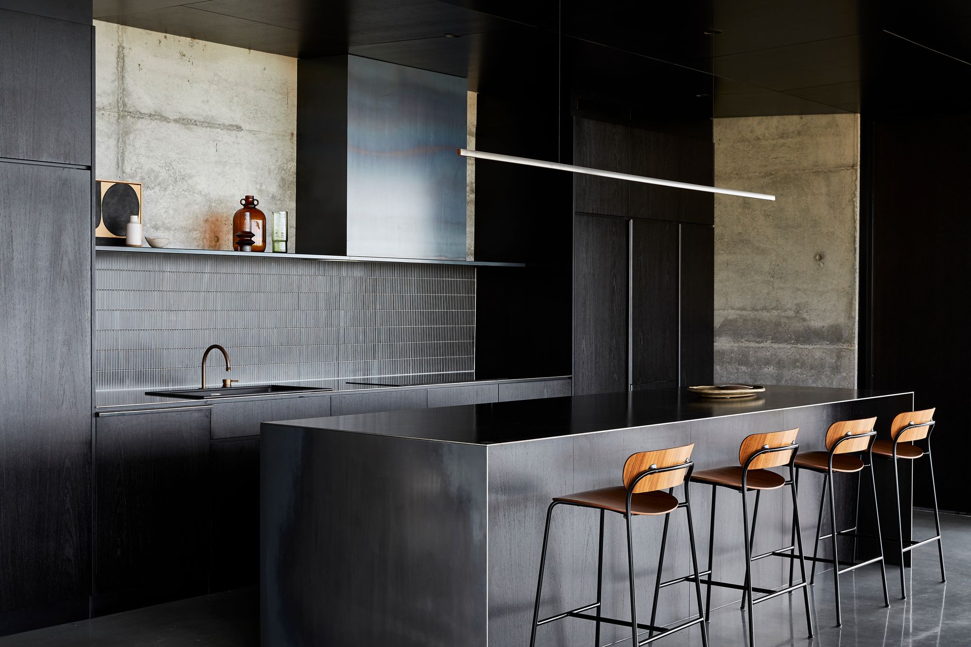 The Point Tasmania.  Kitchen, featuring dark tiles and cabinetry. 