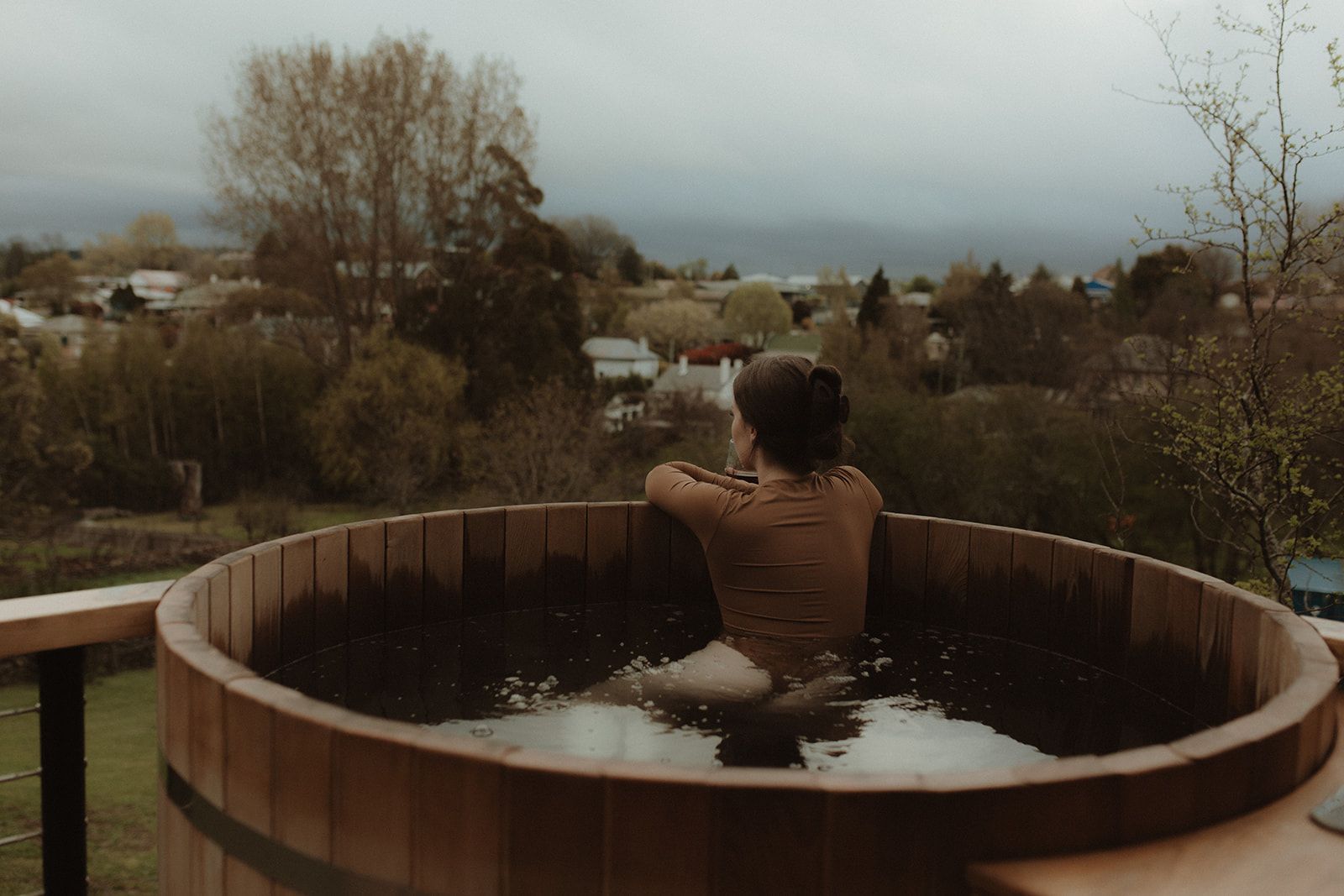 The Eco Cabin Tasmania by Wild Life Environmental. View of Cedar Hot tub looking out at view of tasmanian landscape