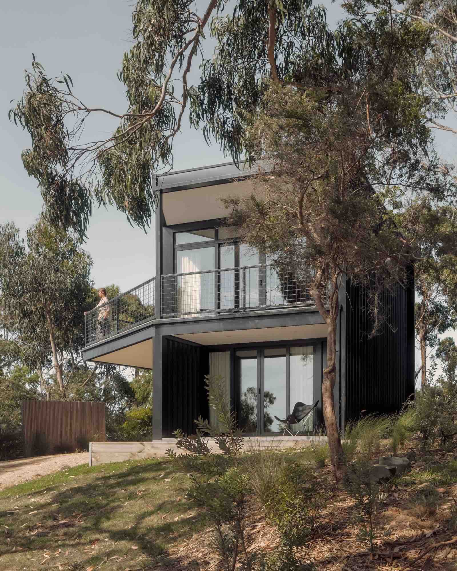 Kennett River House by MGAO showing external facade with person standing on deck