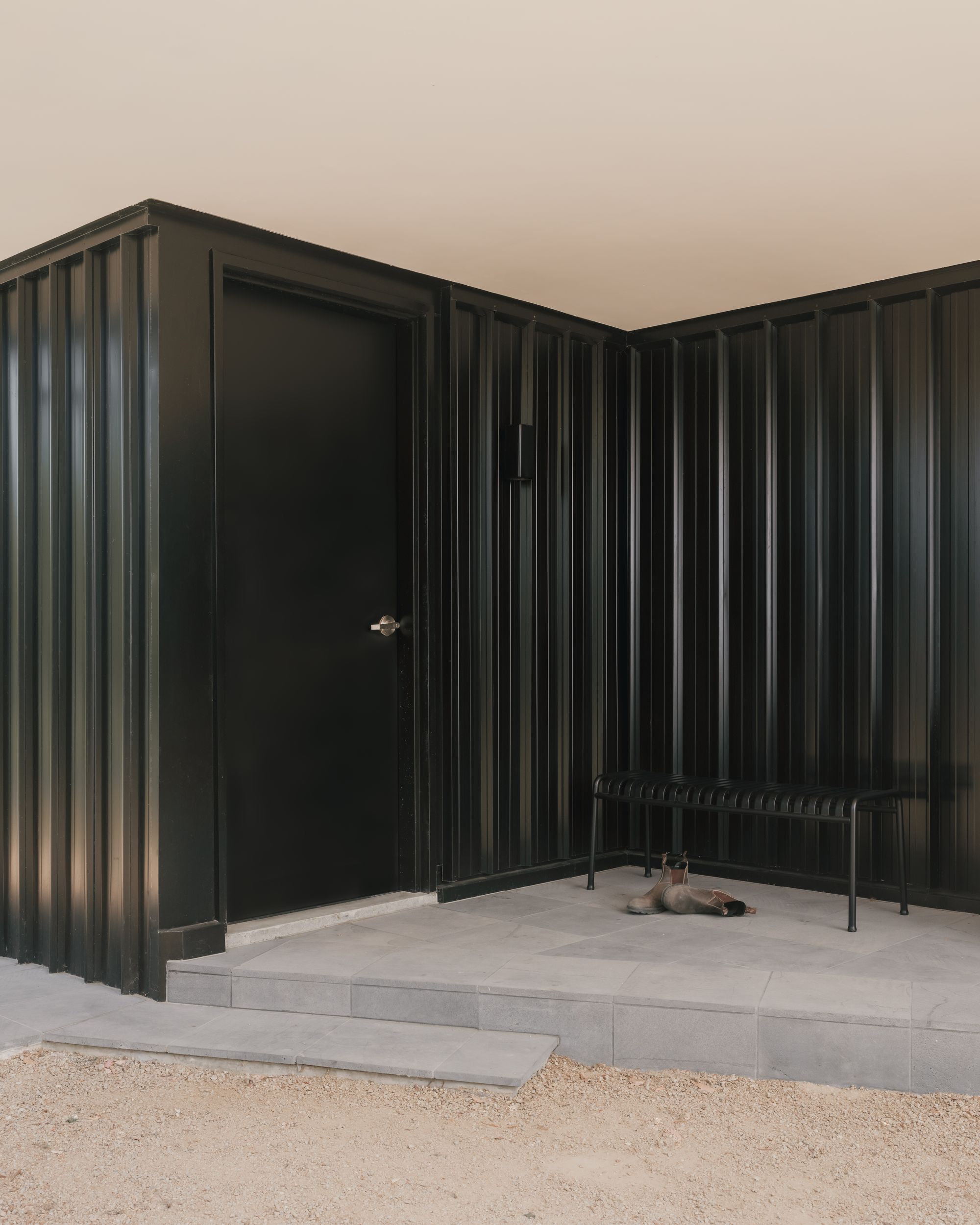 Kennett River House by MGAO showing entry door and bench seat to put shoes on