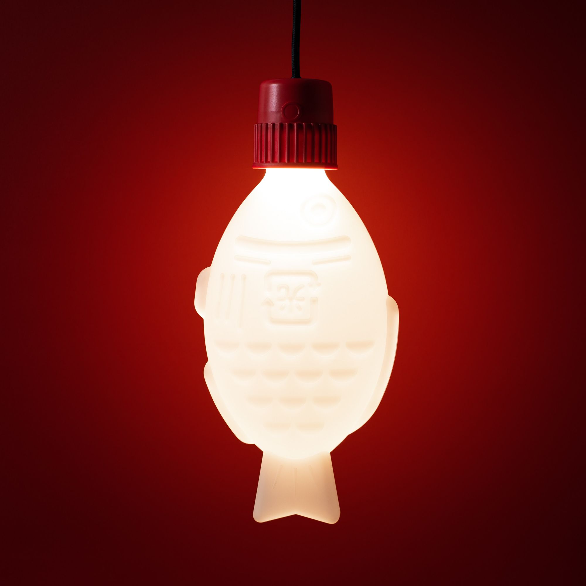 Light Soy by Heliograf showing the pendant light version lit up with a red background