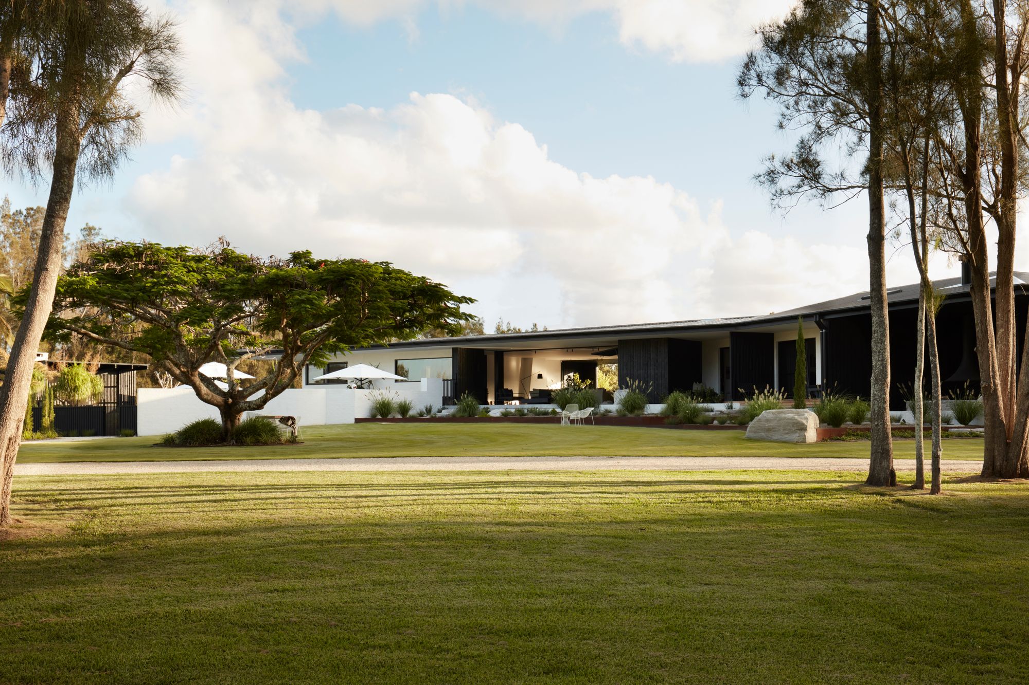 Micalo by Byron Beach Abodes showing front lawn and landscape around the holiday house